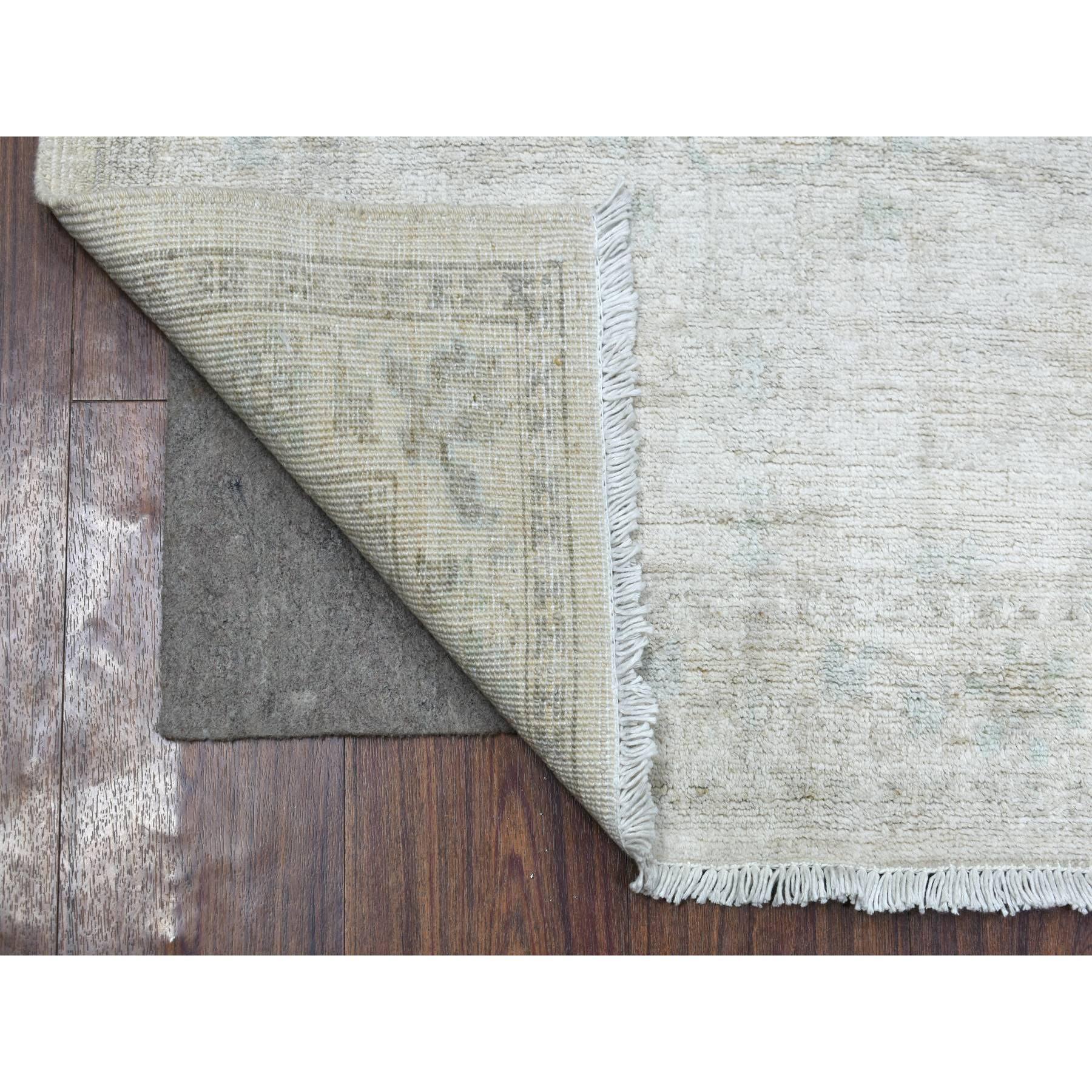 This is a truly genuine one-of-a-kind Ivory Stone Wash Hand Knotted Peshawar with Subtle Design Soft Afghan Wool Oriental Runner Rug. It has been Knotted for months and months in the centuries-old weaving craftsmanship techniques by expert