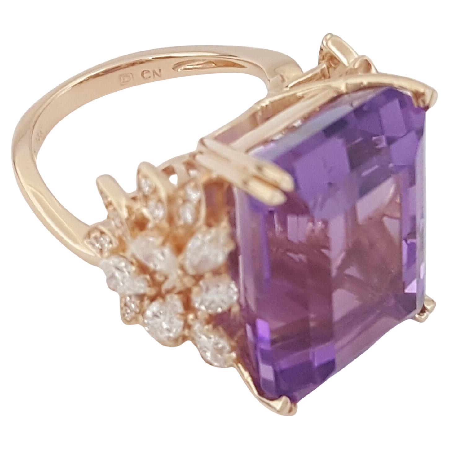 Indulge in luxury with our breathtaking statement ring featuring a stunning 25.85 carat emerald-cut amethyst, adorned with a dazzling array of natural pear, round, and marquise brilliant-cut diamonds. Weighing 13.4 grams and sized perfectly at 7,