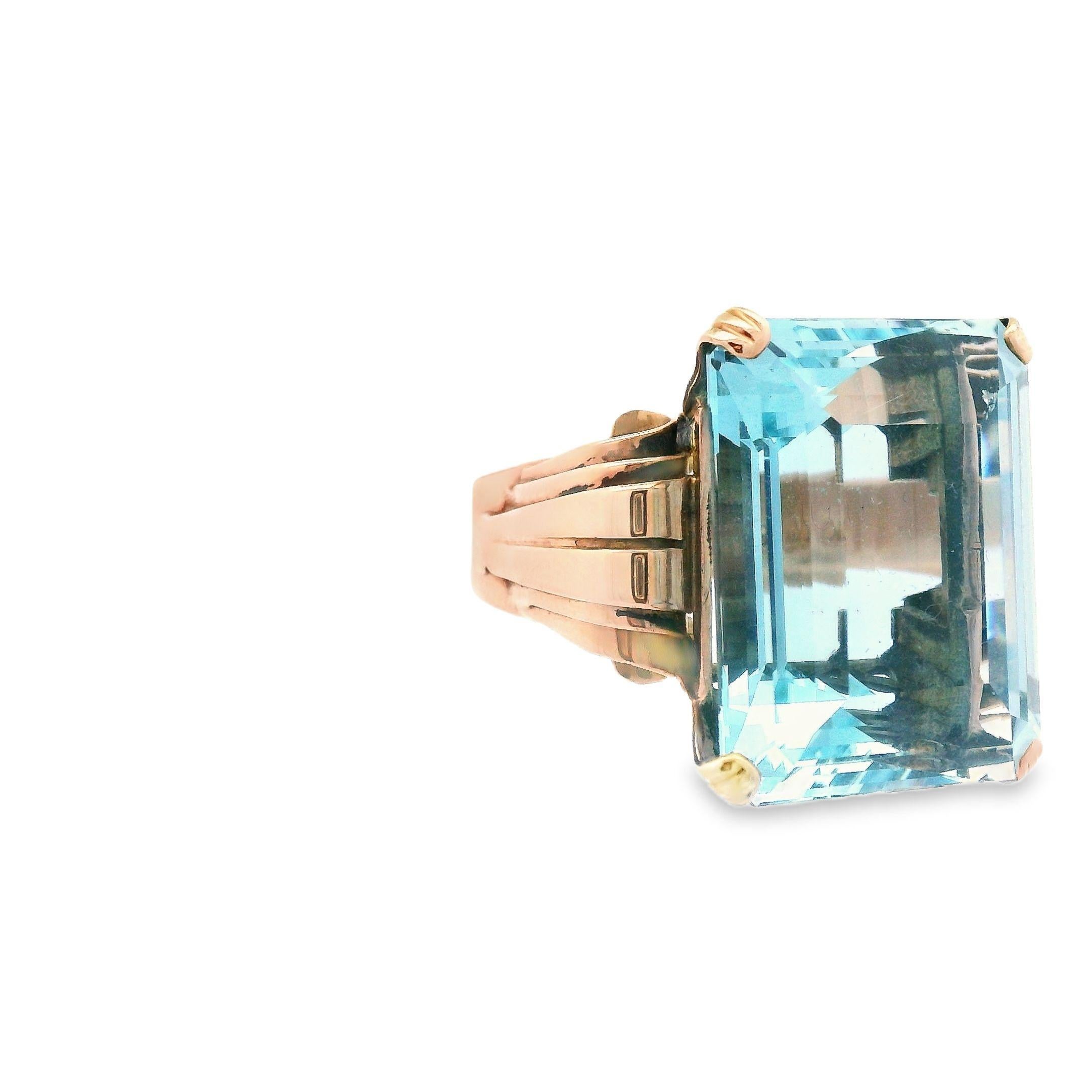 This beautiful aquamarine ring is made with 18k rose gold and is from the Art Deco period. This ring features an unbelievable 28+ carat emerald cut aquamarine that has an enchanting soft blue hue with exceptional presentation. This ring will capture