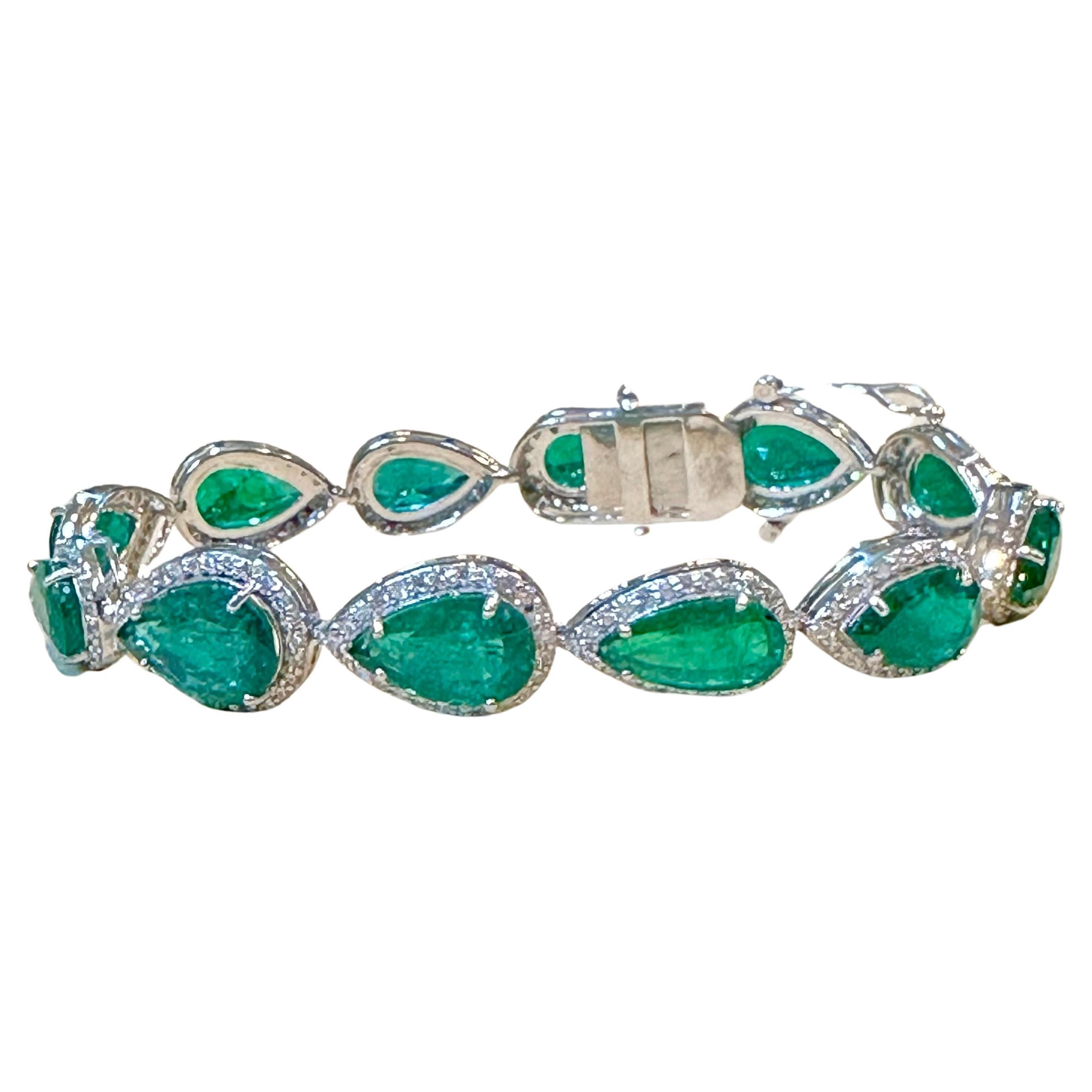 28 Carat Natural Zambian Emerald & Diamond Tennis Bracelet 14 Karat White Gold
 This exceptionally Beautiful Tennis  bracelet has  12 stones of large natural Pear shape  Emeralds  . Each Emerald is surrounded by brilliant  cut round diamond . Total