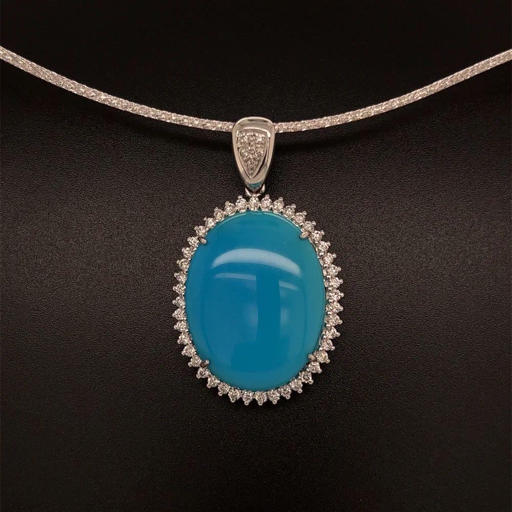 Simply Beautiful! Turquoise and Diamond Gold Halo Pendant Necklace. Centering a 28 Carat Cabochon Turquoise. Surrounded by Diamonds, weighing approx. 0.85tcw. Hand crafted in 18K White Gold. Suspended from a 2-tone Gold choker, measuring approx. 