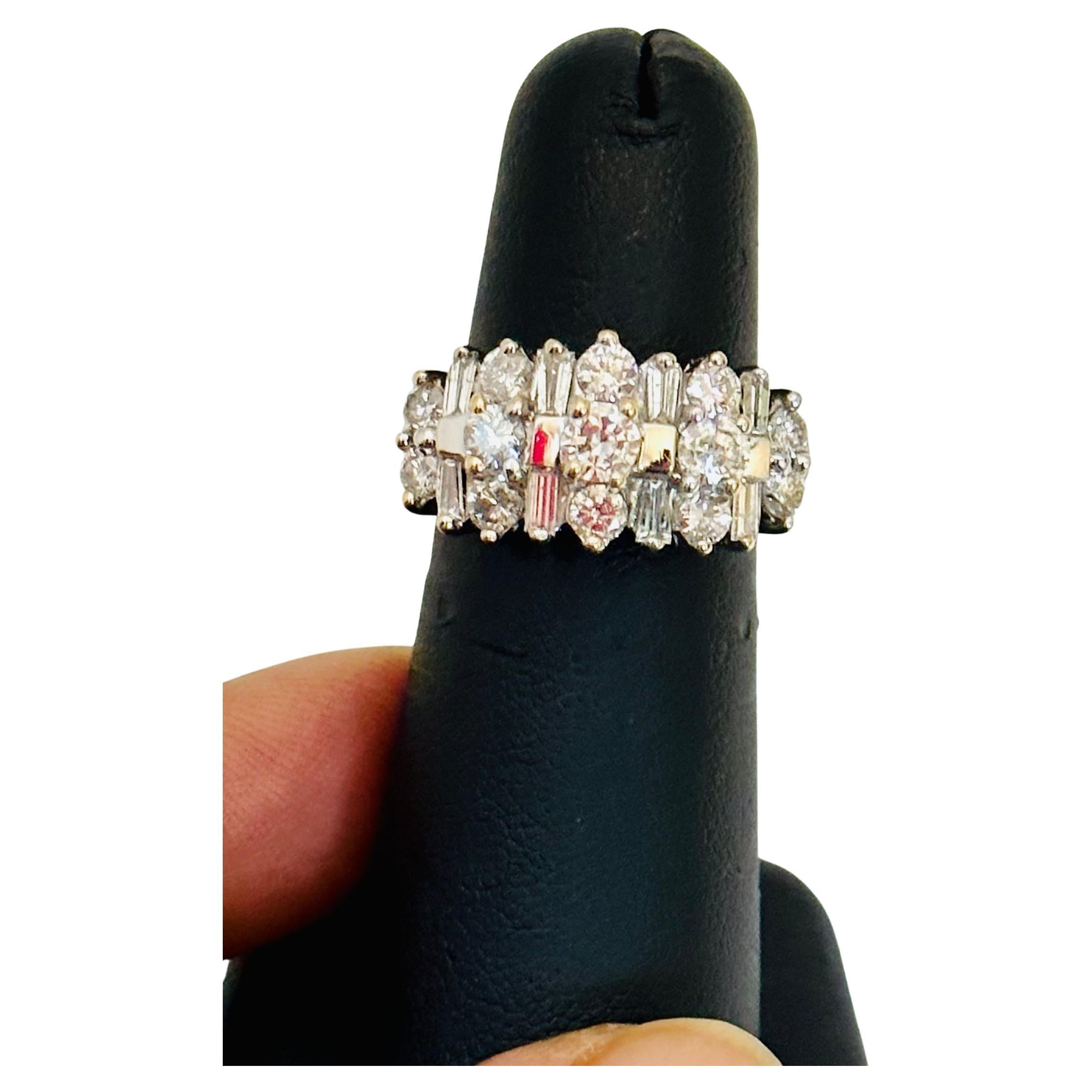 beautiful estate piece
Big size round diamonds alternating with Baguettes are making this beautiful ring.
14 Karat White Gold 6.8 gm
Size 6
Very clean and shiny diamonds.
Total Diamond weight approximately 2.8 ct.
This is a Engagement band  from our