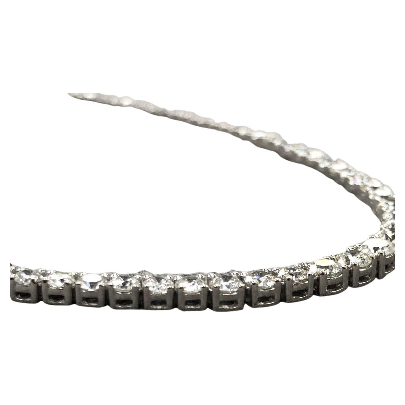 16-inch straight tennis necklace in 18K white gold, featuring 93 round diamonds in a basket prong setting, totaling 28.02 carats.