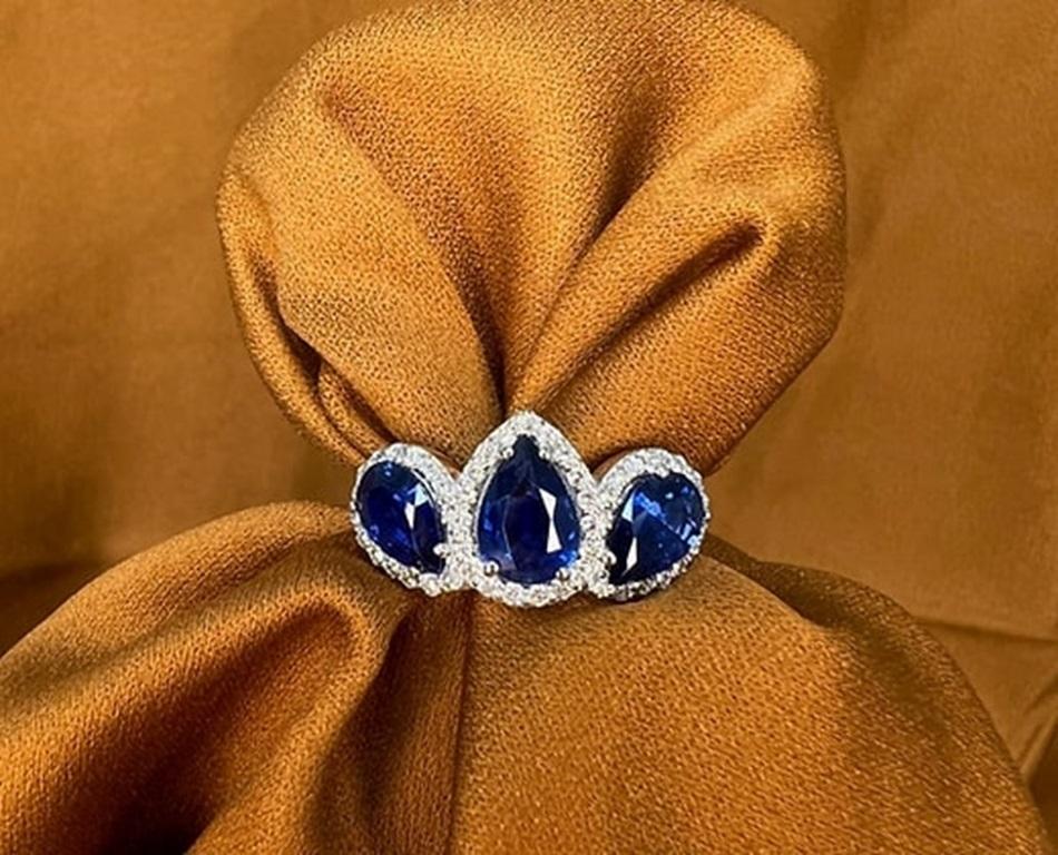 Pear Cut 2.8 Carat Sapphire Pear Three Stone Halo Ring For Sale