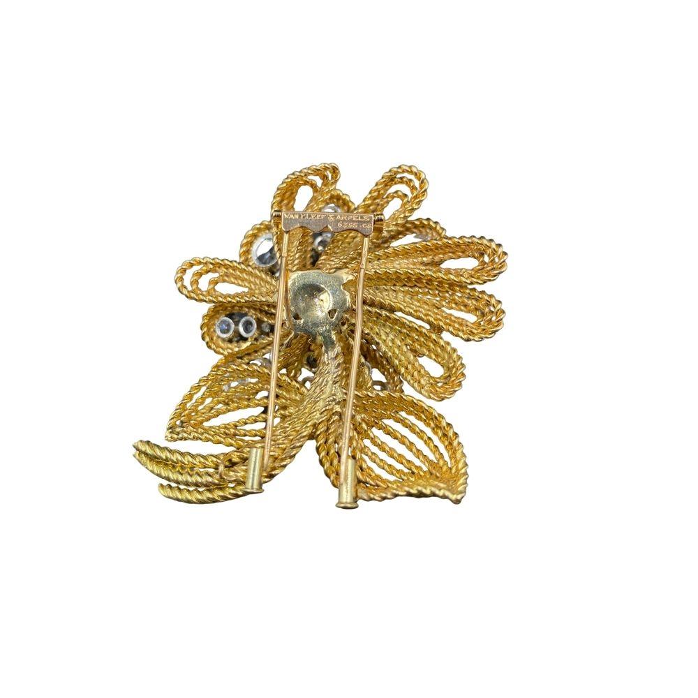 Diamond and Gold Pin by Van Cleef and Aprels, featuring twenty-five carats of diamonds, set in a floral motif. 
Details
Metal  Gold 
Diamond Old European Cut 
Color E-F 
Clarity VS2 

 