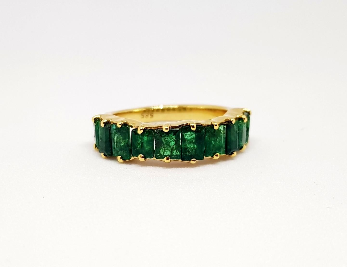 Here is a statement piece, stylish with powerful hues of natural Zambian Green Emeralds. Deep and light playful shades of velvety green emerald baguette cut,  set in a freeform half eternity band, a timeless piece, is the perfect ring made to last.