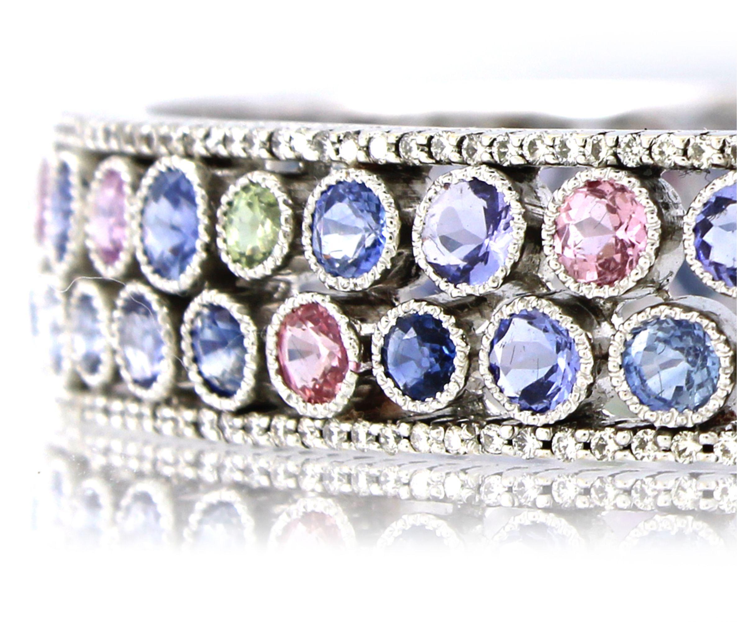 This stunning bangle is a vibrant celebration of color and elegance, making it a standout accessory for any party or special occasion. Crafted in 18k white gold and weighing 51.48 grams, it features 28.0 carats of round-cut multi-colored sapphires,