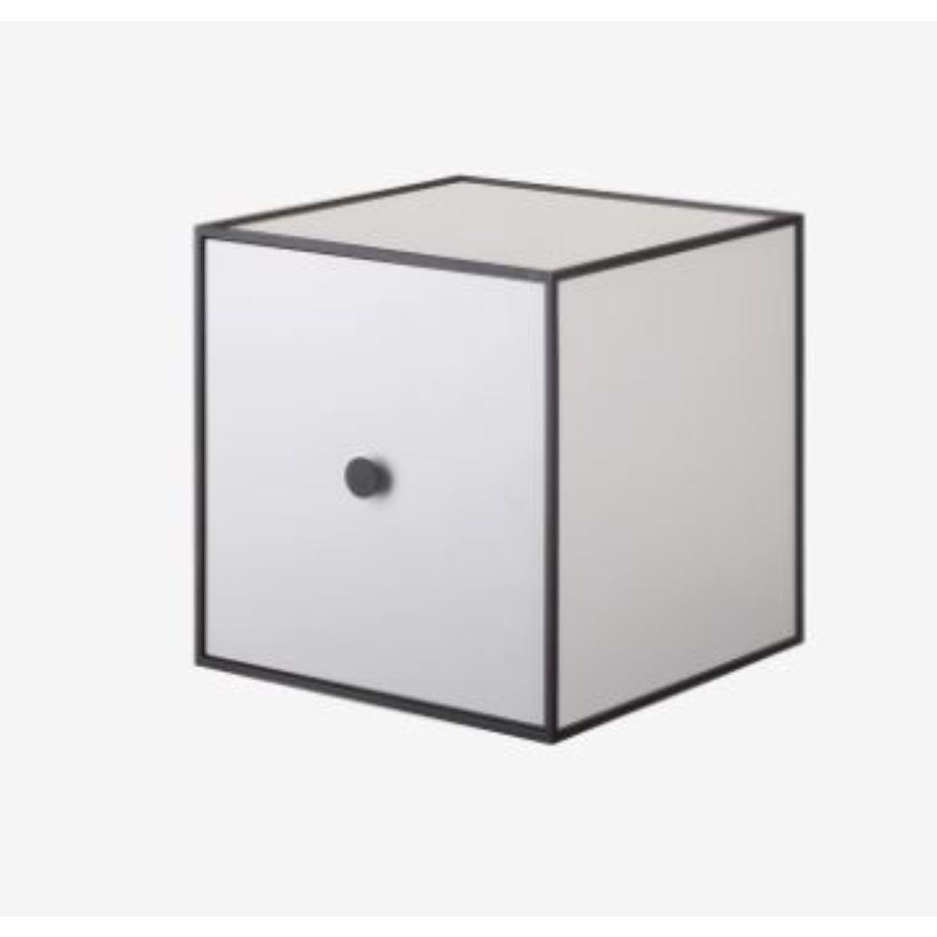 28 light grey frame box with door by Lassen
Dimensions: w 28 x d 28 x h 28 cm 
Materials: Finér, Melamin, Melamin, Melamine, Metal, Veneer
Also available in different colors and dimensions. 

By Lassen is a Danish design brand focused on iconic