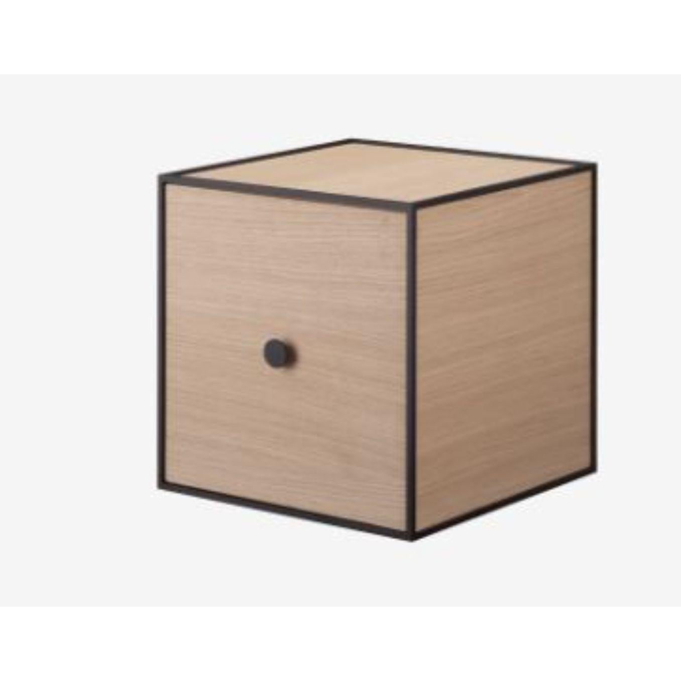 28 oak frame box with door by Lassen
Dimensions: W 28 x D 28 x H 28 cm 
Materials: Finér, melamin, melamin, melamine, metal, veneer, oak.
Also available in different colors and dimensions. 

By Lassen is a Danish design brand focused on iconic
