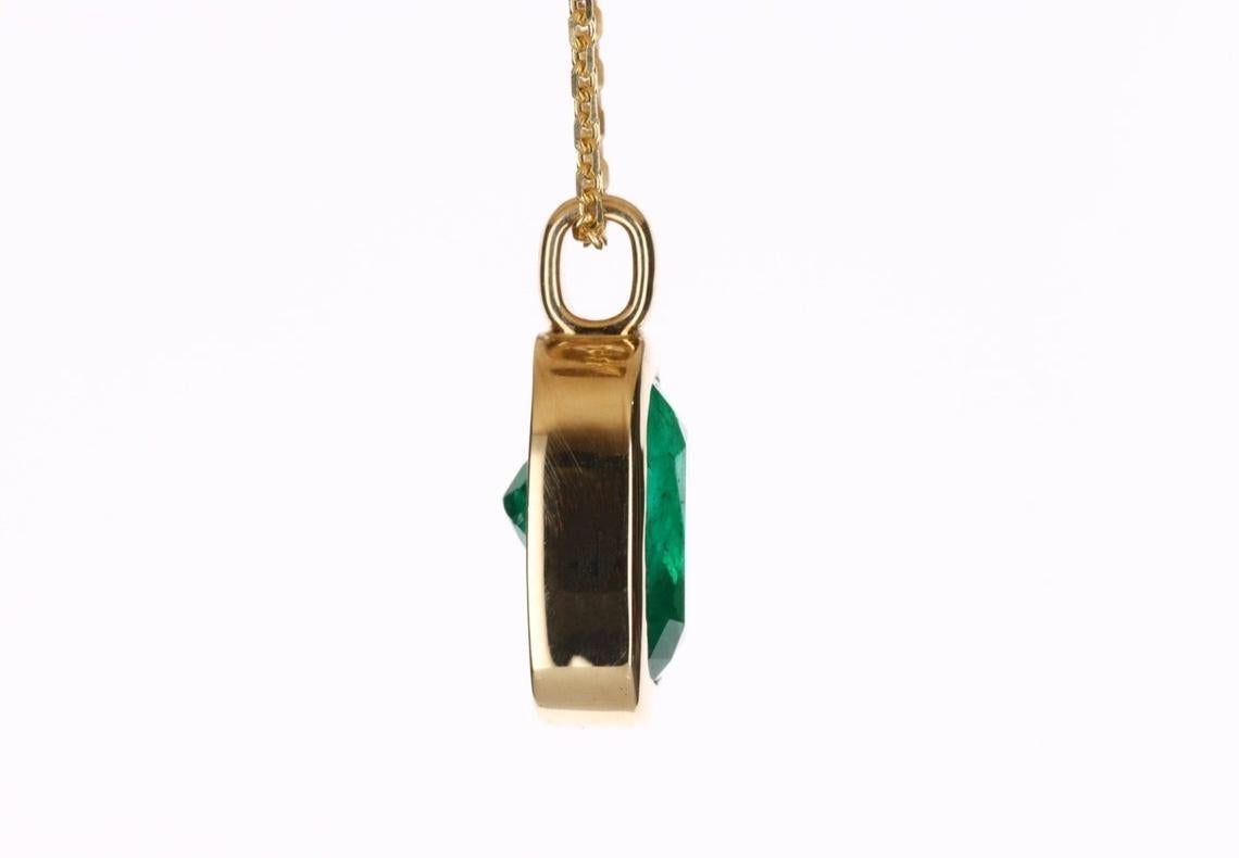 Displayed is a gorgeous 2.80-carat natural Colombian emerald cushion cut solitaire necklace. This is quite the alluring piece with a beautiful center stone. The center gemstone is a good quality Muzo emerald that is handset in a 14K yellow gold