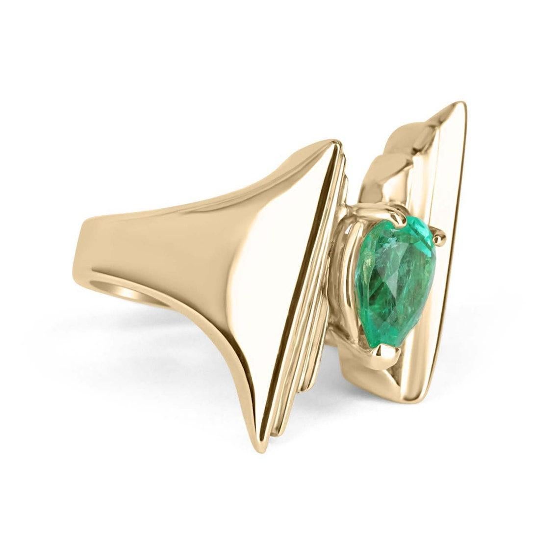 Displayed is a stunning fine quality Colombian emerald solitaire, pear-shaped statement ring in 14K yellow gold. This gorgeous solitaire ring carries a full 2.80-carat emerald in a three prong setting. Fully faceted, this gemstone showcases