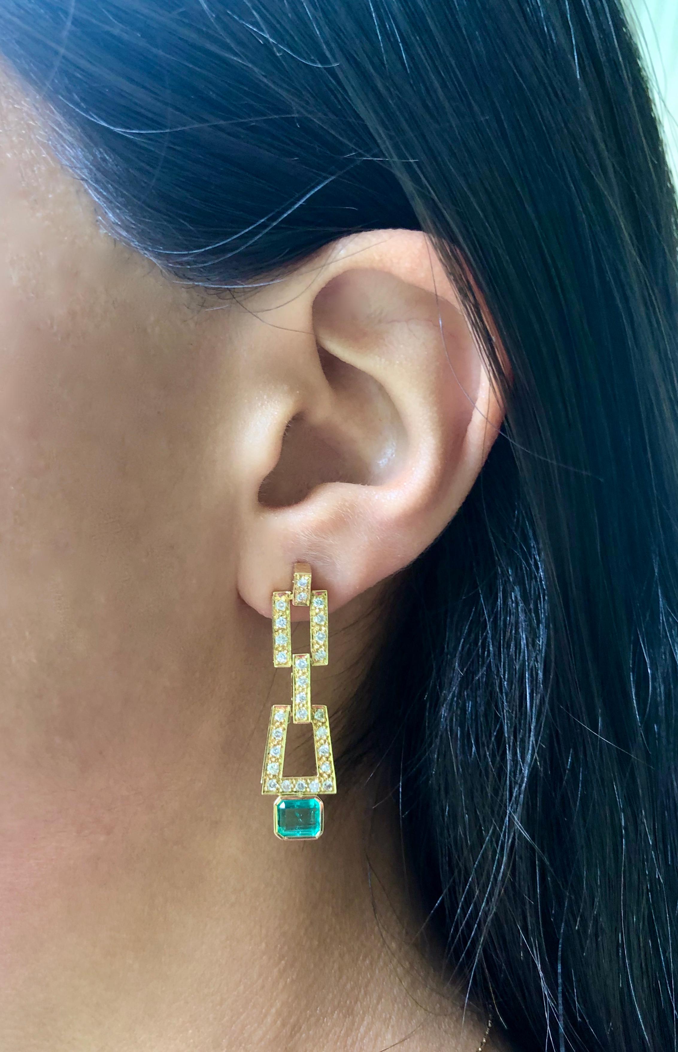 Sophisticated dangle drop earrings! Doesn't need much when you have a gorgeous Colombian emerald paired with white diamonds. These classic and timeless earrings have 1.80 carat natural emerald cut Colombian emerald medium green color, VS in clarity,