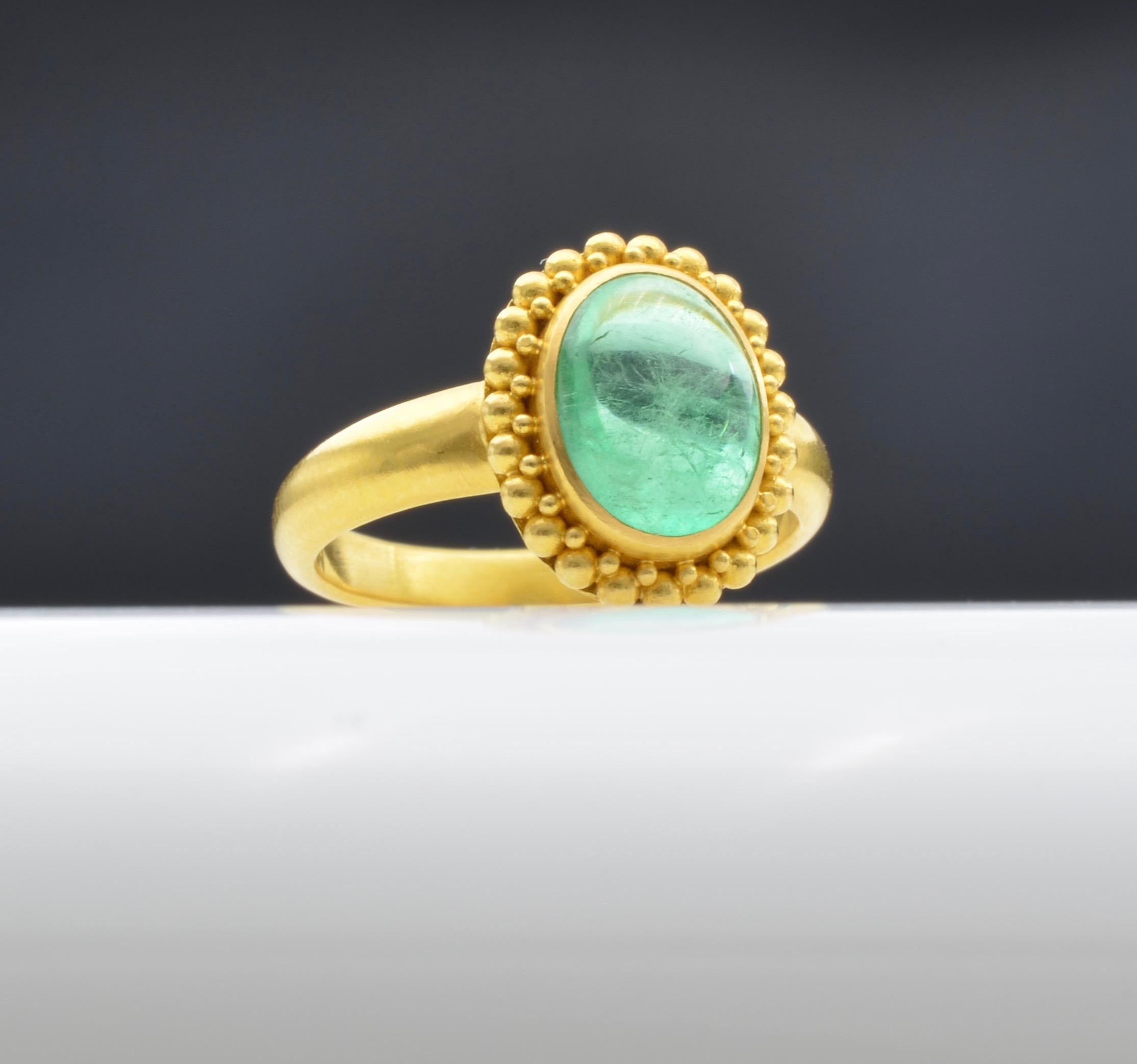 This stunning  approximately  2.80 ct emerald is watery and radiant set in 22k gold to accent the lovely green hue. The ring is a size 6 1/4 and can be sized to fit your finger.