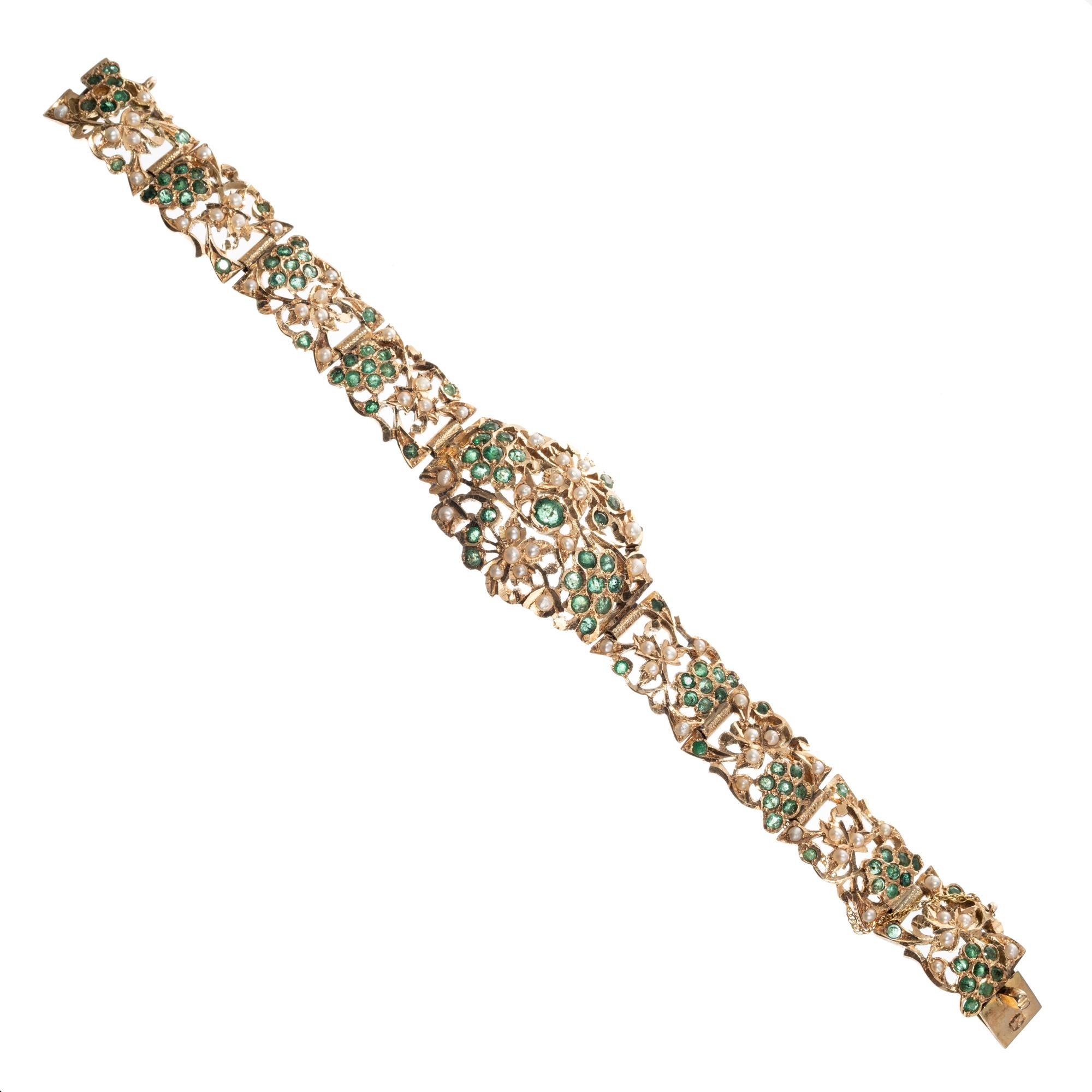 Emerald and pearl hinged link bracelet. 104 round emeralds in an open work 14k yellow gold bracelet with 65 accent seed pearls. 

104 round green emeralds, approx. 2.80cts 
65 crème seed pearls
14k yellow gold 
Stamped: 14k
37.9 grams
Bracelet: 7