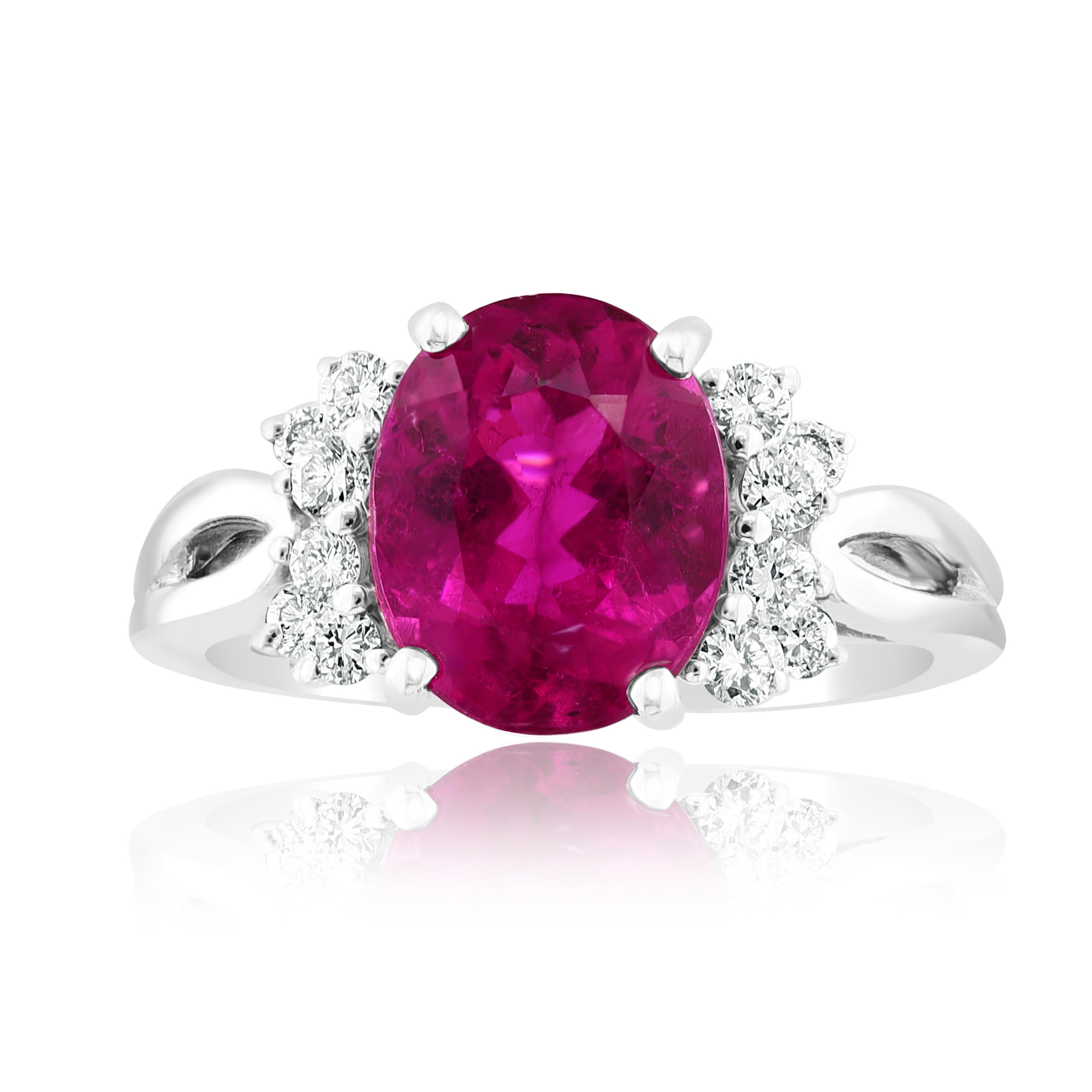 This classic ring with Oval Cut Pink Tourmaline in the center is 2.80 carat with brilliant cut diamonds on both sides. 12 round diamonds and 4 baguette diamonds weigh 0.18 carat and are made of 18K White Gold.