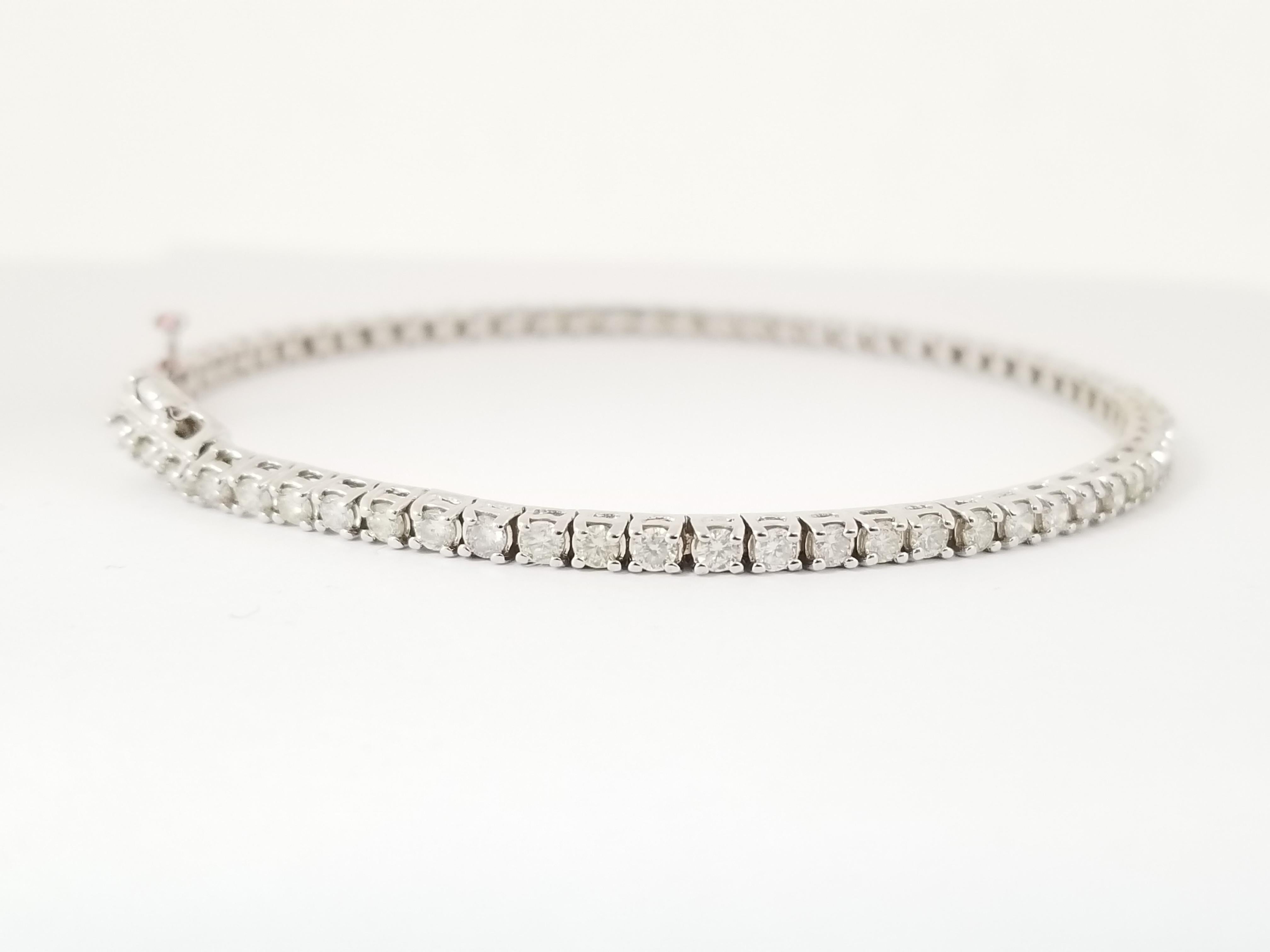 Exquisite style for everyday wear, Beautiful round-brilliant cut diamonds, set on 14k white gold. each stone is set in a classic four-prong style for maximum light brilliance. 7 inch length. Color I, Clarity VS. 2.5 mm wide. Luxury for every moment.