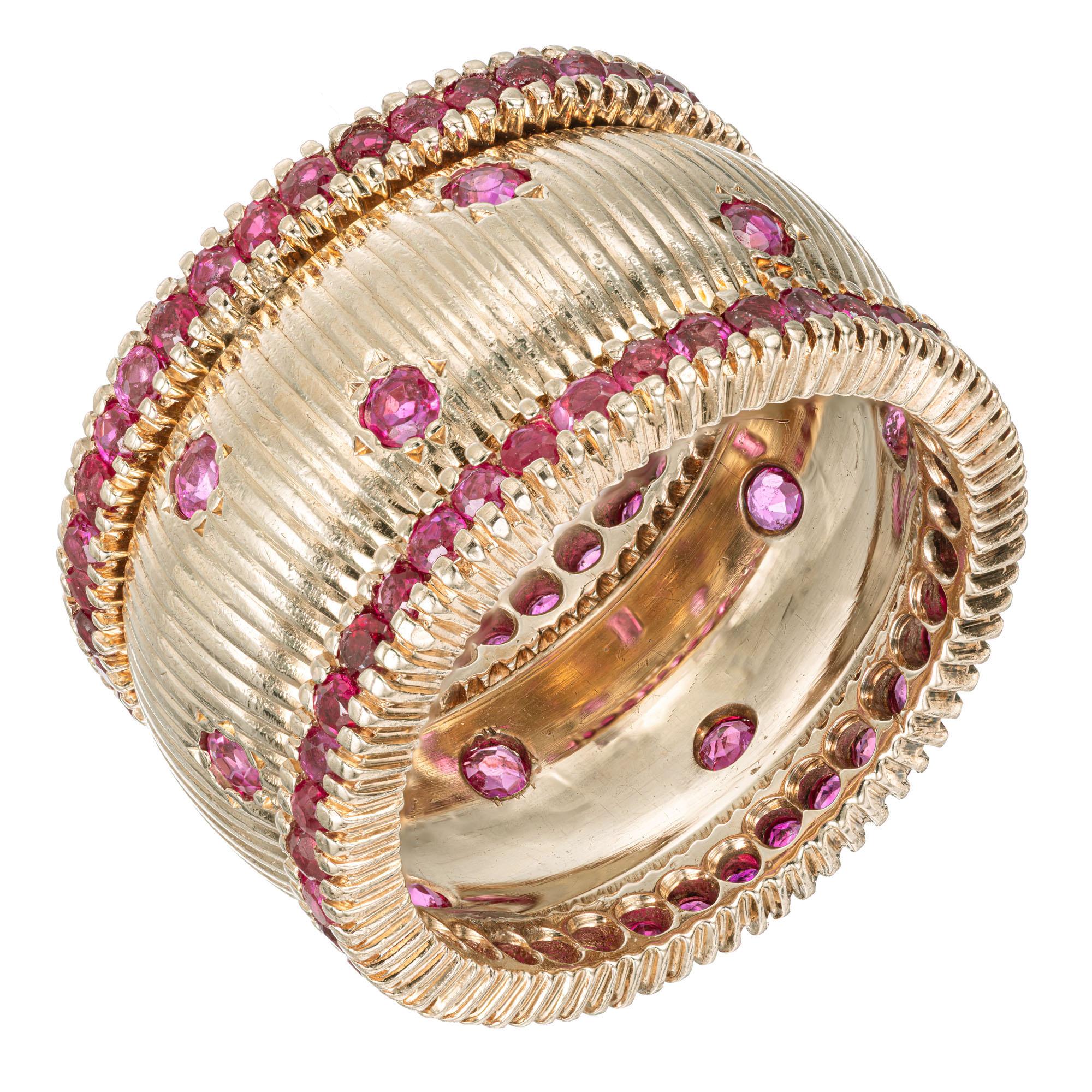 1950's Ruby yellow gold band ring. 76 round rubies along both rims of the setting accented with 12 round rubies along the 14k rose gold wide textured setting. 

12 round Rubies, approx. total weight .60cts, VS-SI, 2mm, genuine bright
76 round