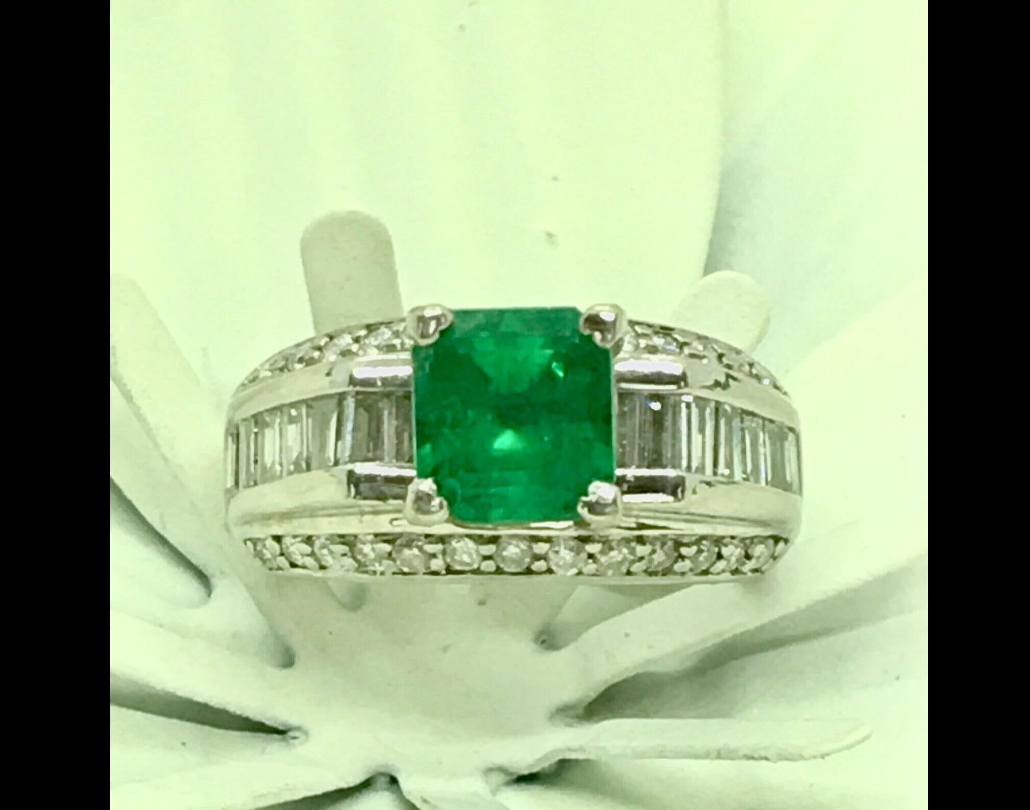 This stunning Engagement Ring is centered by one natural Colombian emerald square cut 1.10 carat, with an intense green color, fine quality.
The Ring are feature by 26 side round natural diamonds that total .50 carat and
14 baguette diamond that