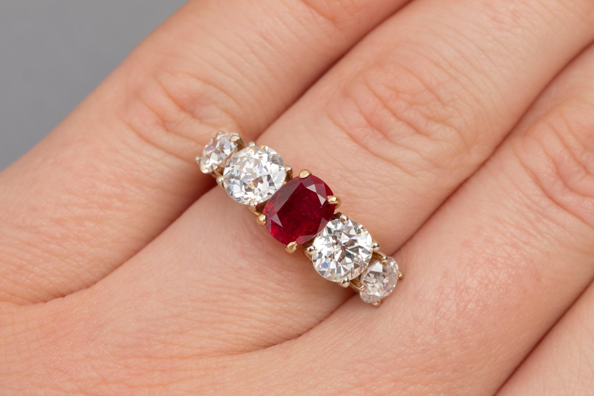 Beautiful bad ring, made in France in the first half of 20th century.  
The ring is Mounted with yellow gold 18k (Hallmark: The owle ) 
 The ring is set with a Red Ruby of 1.20 carats approximately. The stone is very clear.  The two diamonds on each