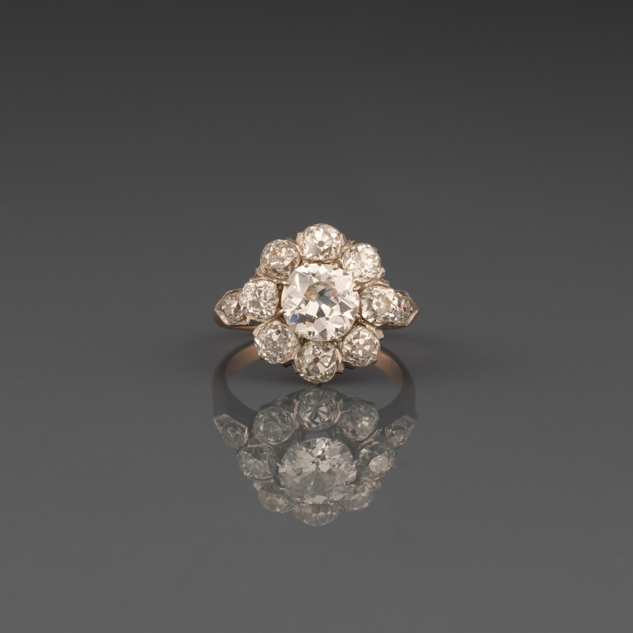 A very beautiful antique, with an history. The ring stayed in the same family since the 1860's. 

The ring is made in rose and white gold 18K. The diamonds weights 2.80/3 Carats total approximately: 1.20fort the central plus 0.20/0.25*8. They are