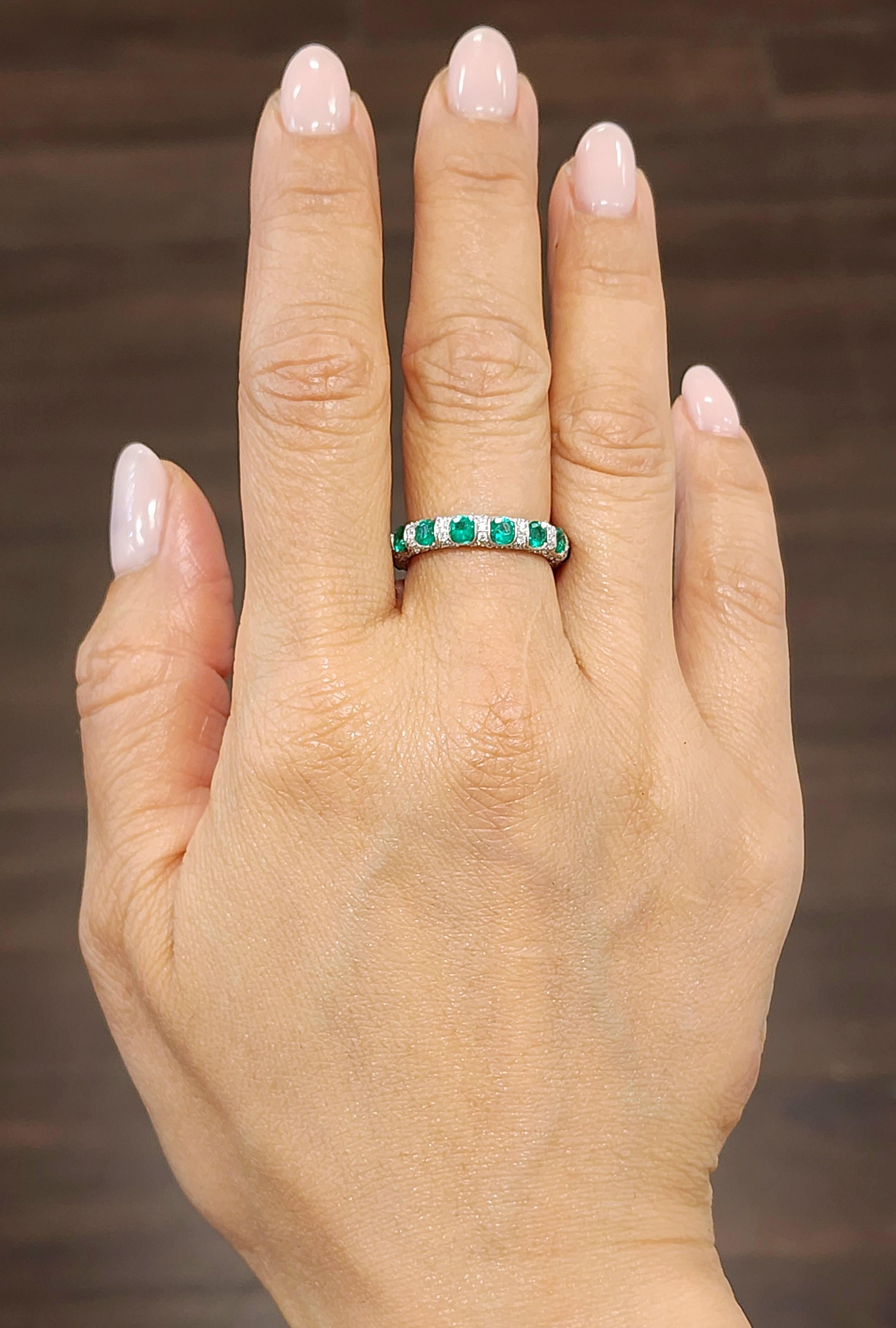Beautiful natural emerald and diamond eternity band. The band features 14 round brilliant emeralds weighing 1.58 ct and 154 diamonds weighing 1.22 ct set in 18k white gold.