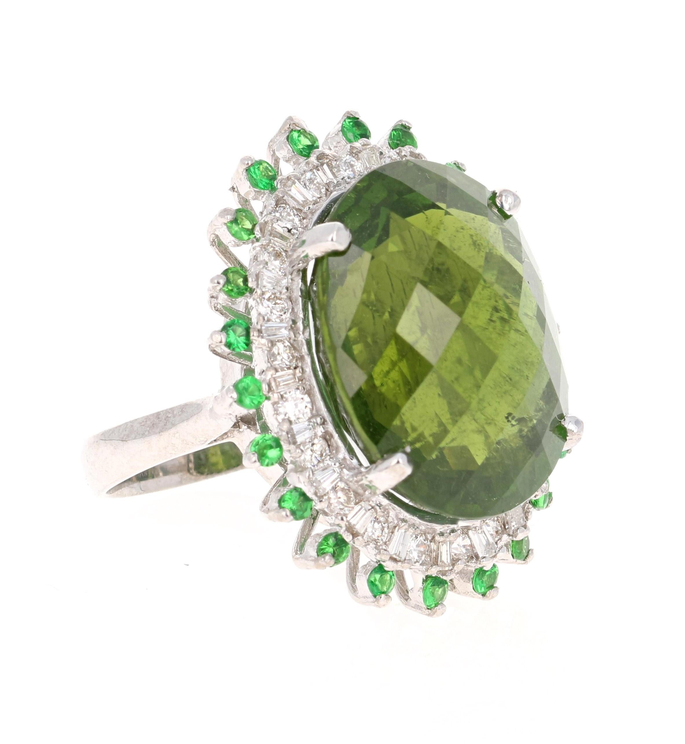 A beauty that is sure to be nothing less than a statement! 

This ring has a magnificently beautiful and large Oval Checkered Cut Green Tourmaline that weighs 26.25 Carats. The green tourmaline has hues of olive green and jungle green and has 44