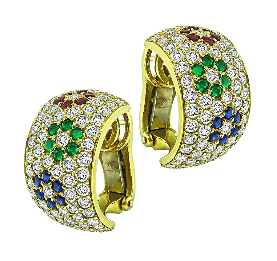 This is a stunning pair of 18k yellow gold earrings. The earrings feature sparkling round cut diamonds that weigh approximately 2.80ct. The color of these diamonds is E-F with VS clarity. The earrings are accentuated by lovely round cut rubies,