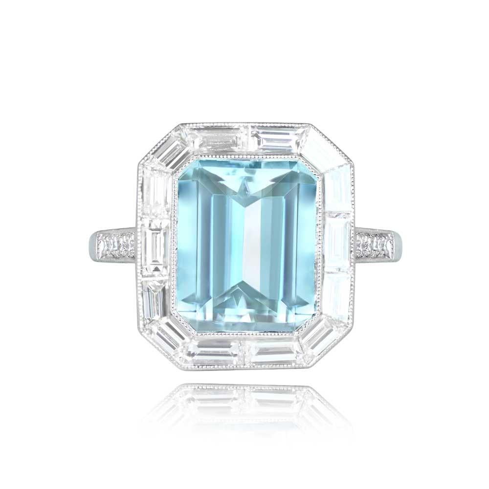 A geometric gemstone and diamond ring with an emerald-cut aquamarine, weighing about 2.80 carats, framed by a halo of calibre baguette-cut diamonds. The platinum ring also showcases round brilliant-cut diamonds along the shoulders, totaling