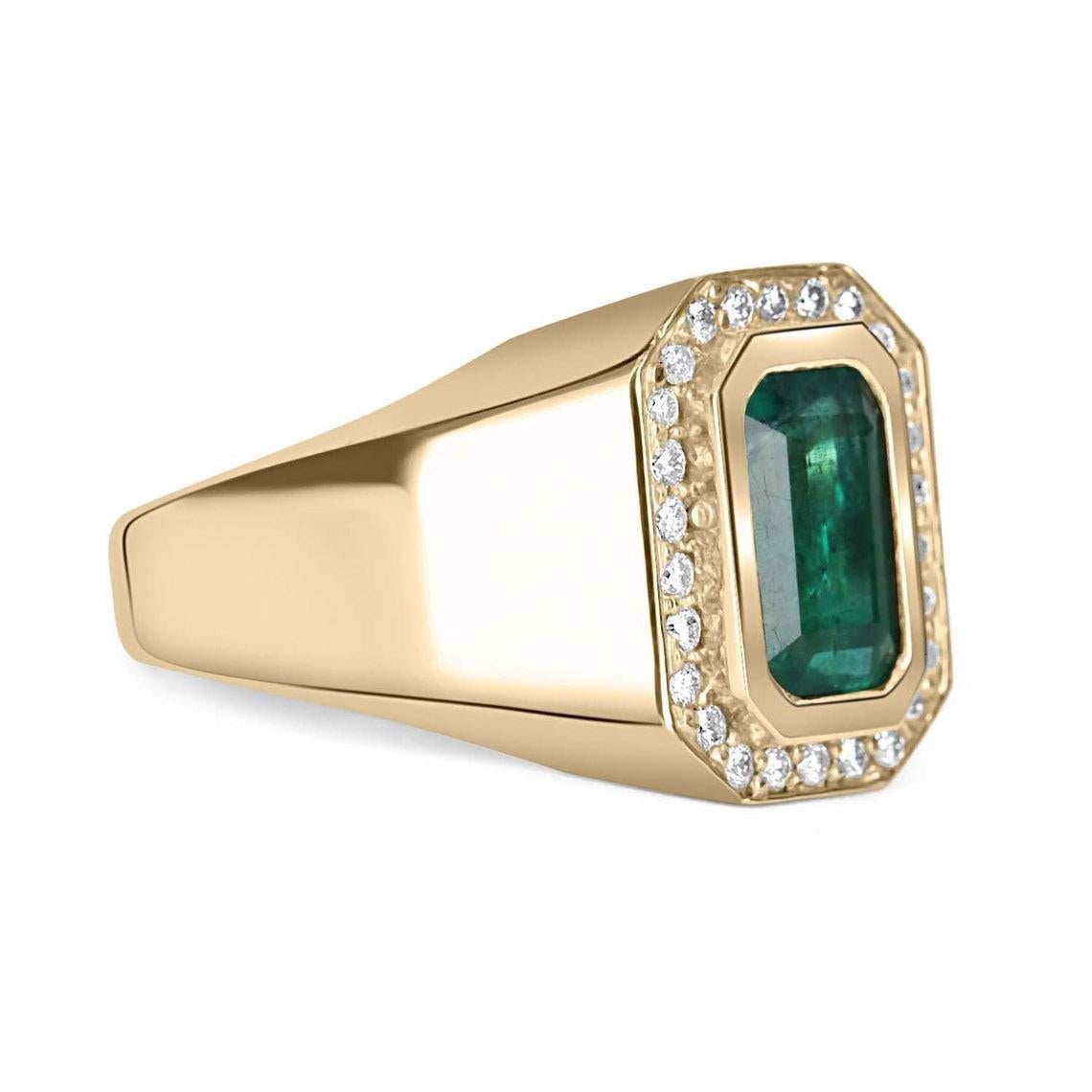 An important Colombian emerald and diamond men's cocktail ring. A large 2.50-carat emerald is bezel set in the very center. The men's ring is made in solid 14K yellow gold and is accented by brilliant round diamonds. This ring has excellent spread
