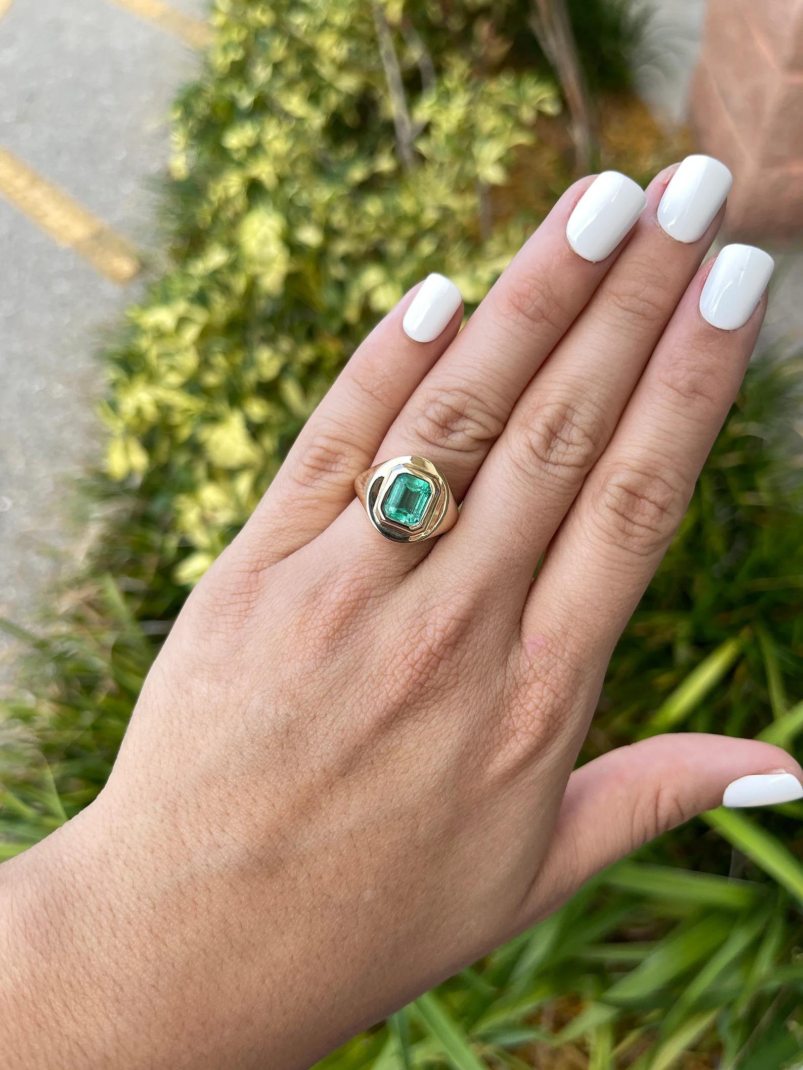 Take a look at this alluring emerald solitaire gold ring. The center gemstone holds 2.81-carats of pure natural Colombian emerald bliss. The gemstone showcases an enticing spring green color, with a faint bluish-green hue. Excellent luster and eye