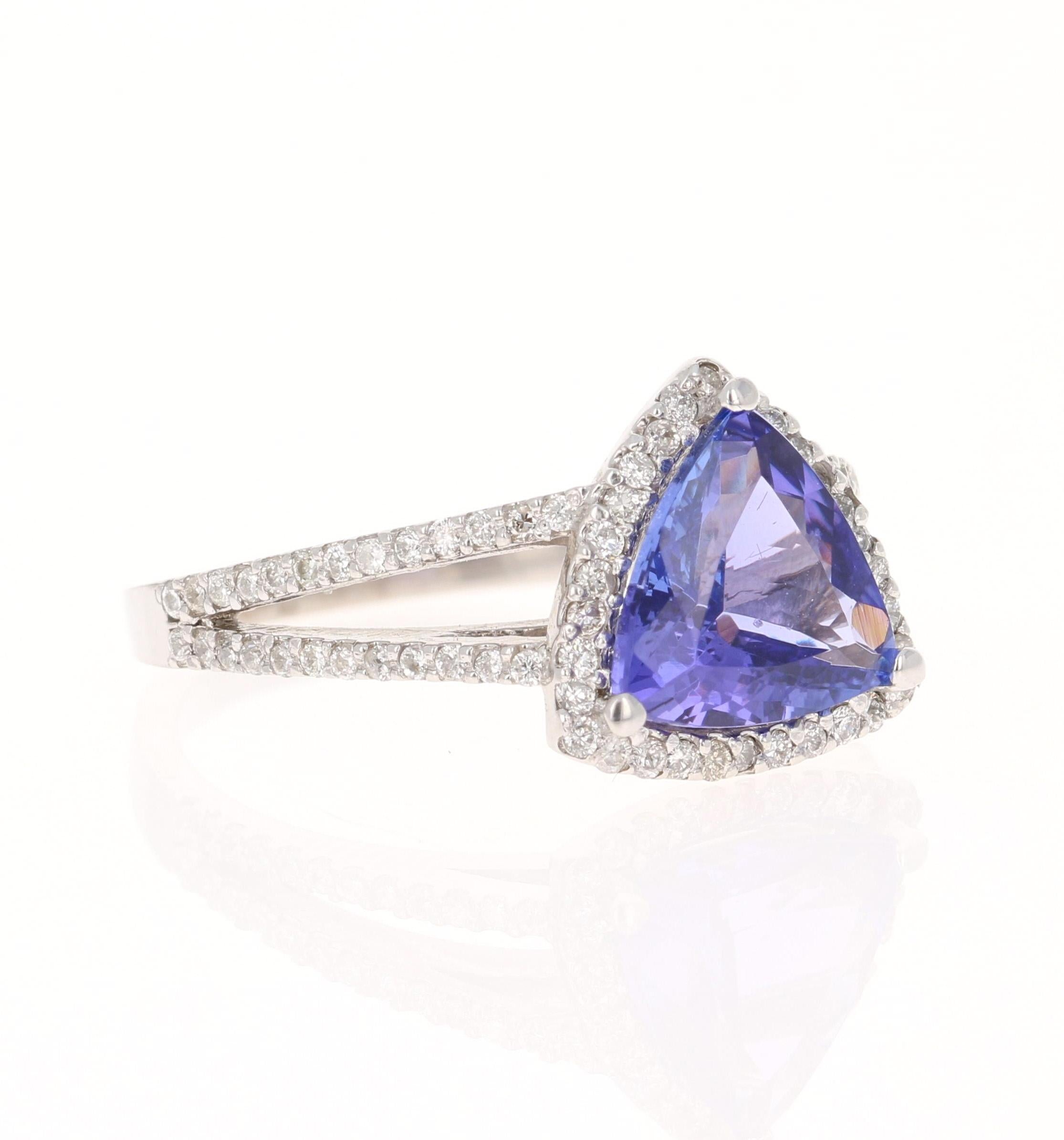 This ring has a gorgeous Trillion Cut Tanzanite that weighs 2.41 Carats. It is surrounded by 78 Round Cut Diamonds that weigh 0.40 Carats. The total carat weight of the ring is 2.81 carats. 

Elegantly set in 14 Karat White Gold and weighs