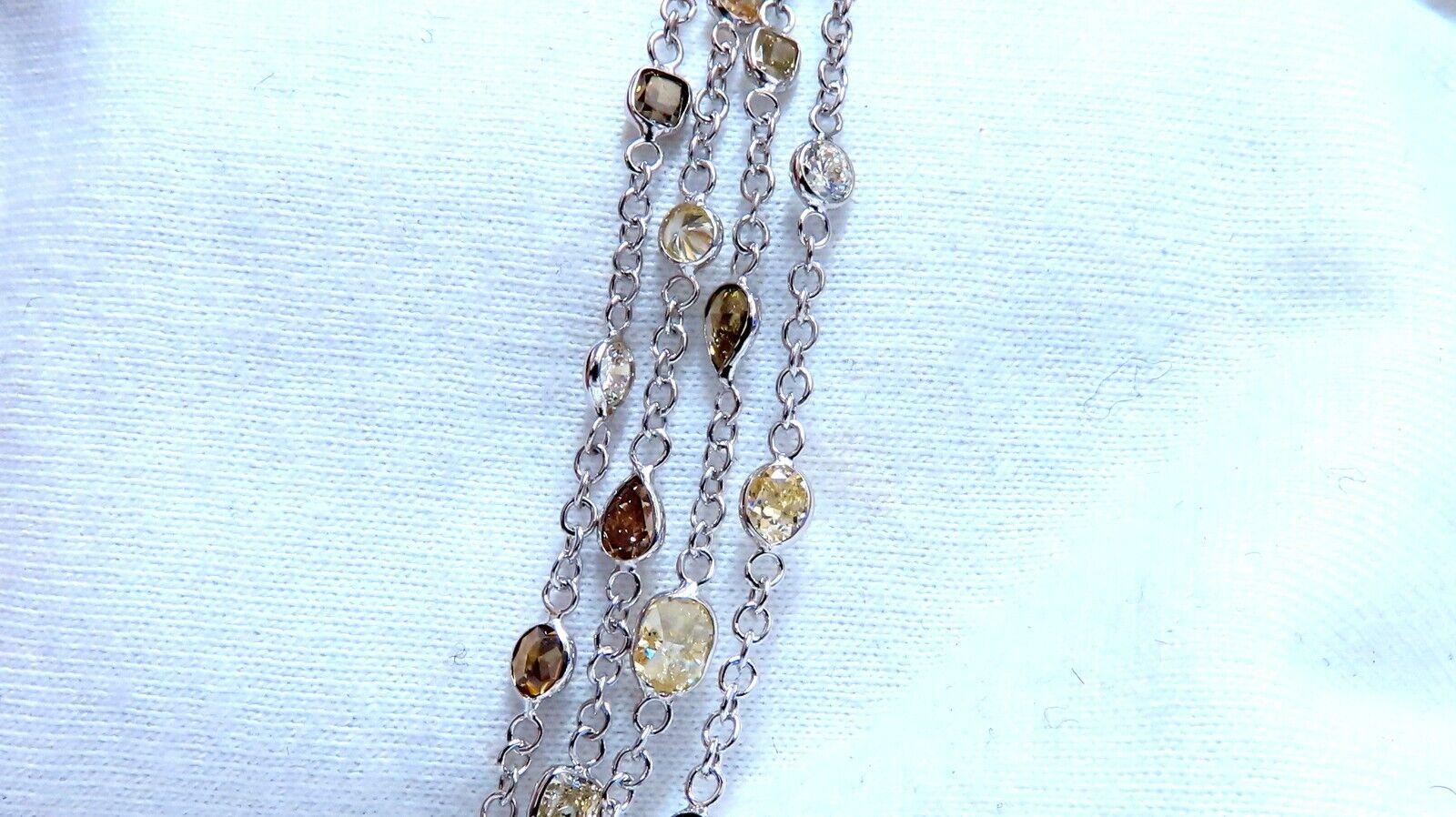 28.18ct. Diamonds Station Yard Necklace. 

Natural Fancy Colors 

Olive Green, Yellow, Orange, Brown, pink and white diamonds.

Mulishaped, Full cuts.
Vs-1 Vs-2 Si-1 clarity.


Total Necklace Length: 22 Inch.

18Kt White gold 

20.9 Grams

Diamonds