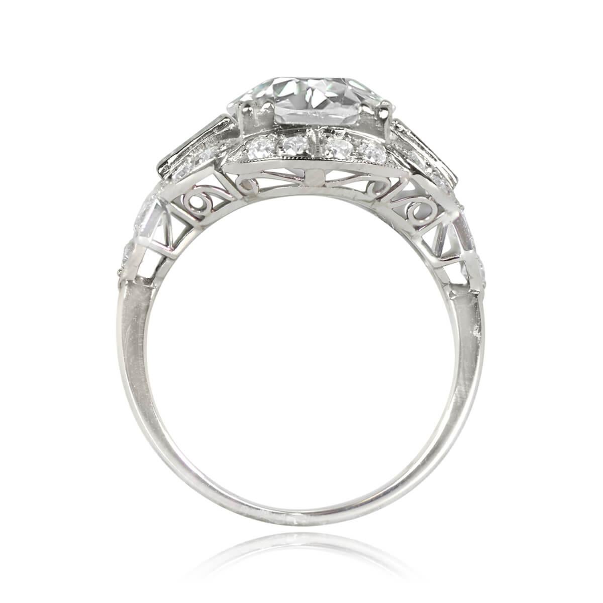 This exquisite ring showcases a 2.81-carat old European cut diamond with K color and VS1 clarity, elegantly secured in prongs. Accompanying the center stone, baguette-cut diamonds are artfully placed on either side, oriented east-west. An enchanting
