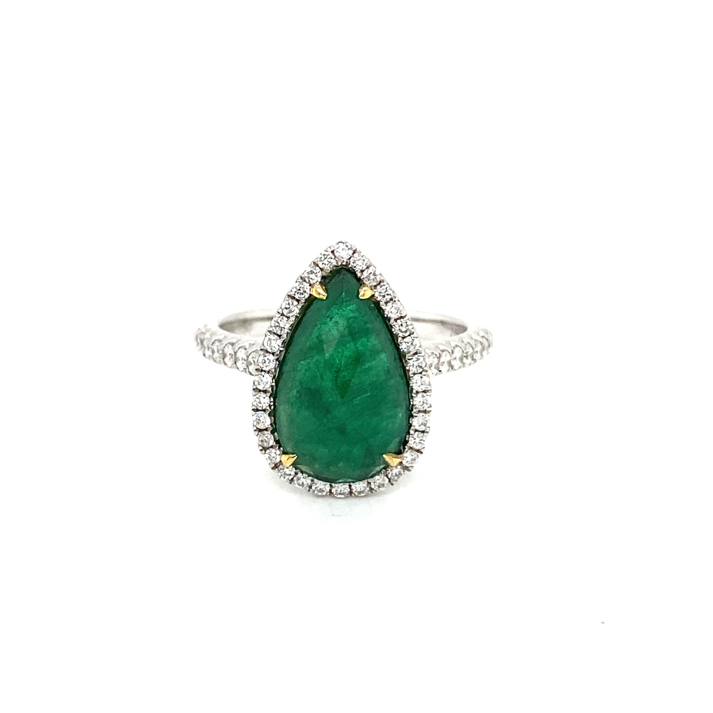 This stunning cocktail ring features a beautiful 2.82 Carat Pear Shape Emerald with a Diamond Halo on a Diamond Shank. This ring is set in 18k White Gold with 18k Yellow Gold Prongs on the center stone. 
Total Diamond Weight = 0.38 Carats. Ring Size