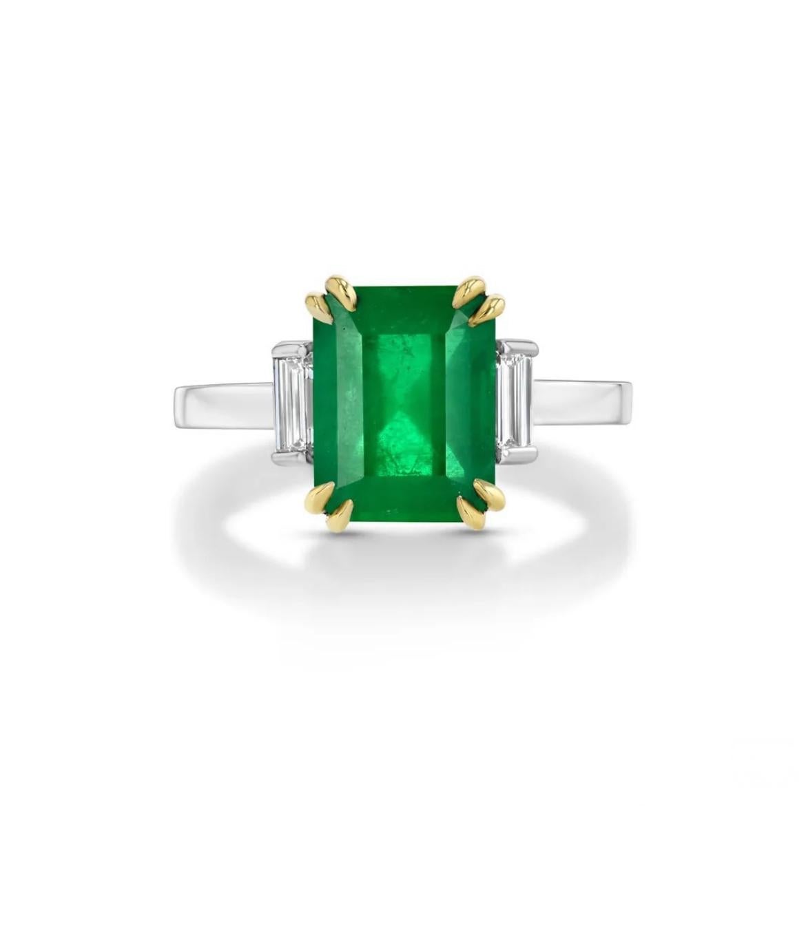 18K white with yellow gold ring, featuring a 2.82-carat GIA certified Zambian Emerald, flanked by two baguette diamond totaling 0.30cts. 