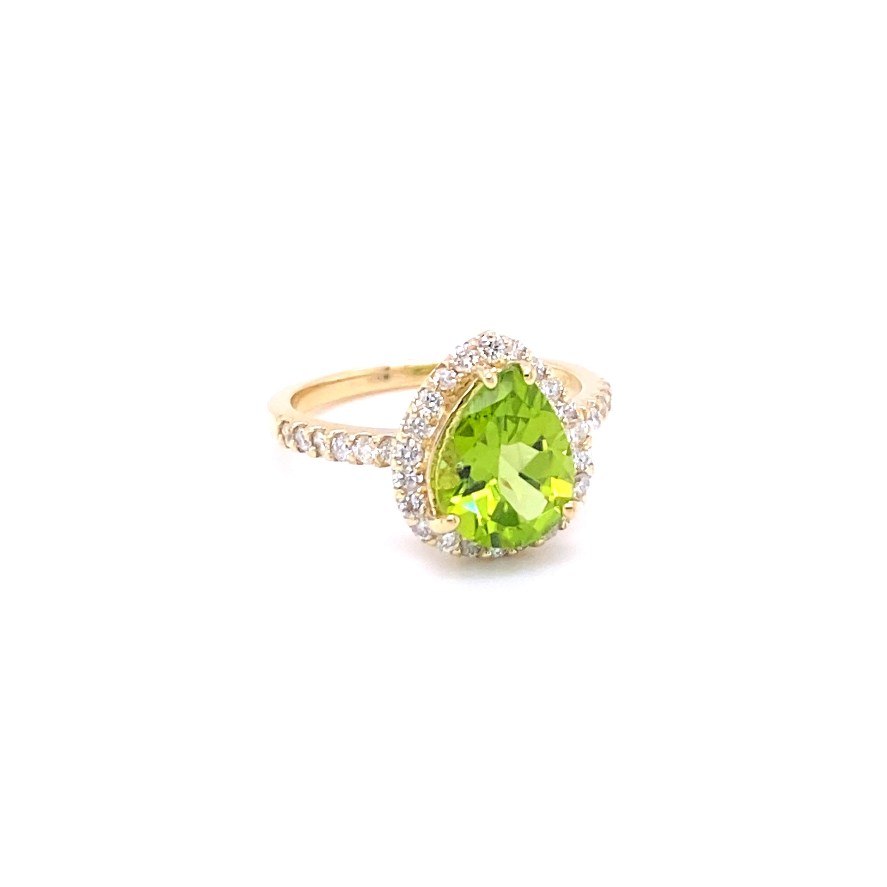This beautiful Ring has a Pear Cut Peridot in the center that weighs 2.25 Carats. The ring is surrounded by a Halo of 34 Rounds Cut Diamonds that weigh 0.57 Carats. The Total Carat weight of the ring is 2.82 Carats. The Diamonds have a Clarity of