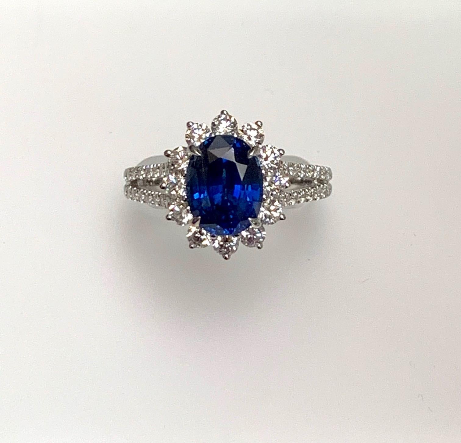 2.82 Carat oval sapphire set in 18k white gold ring with 0.97 ct diamonds around it and on th split shank .
