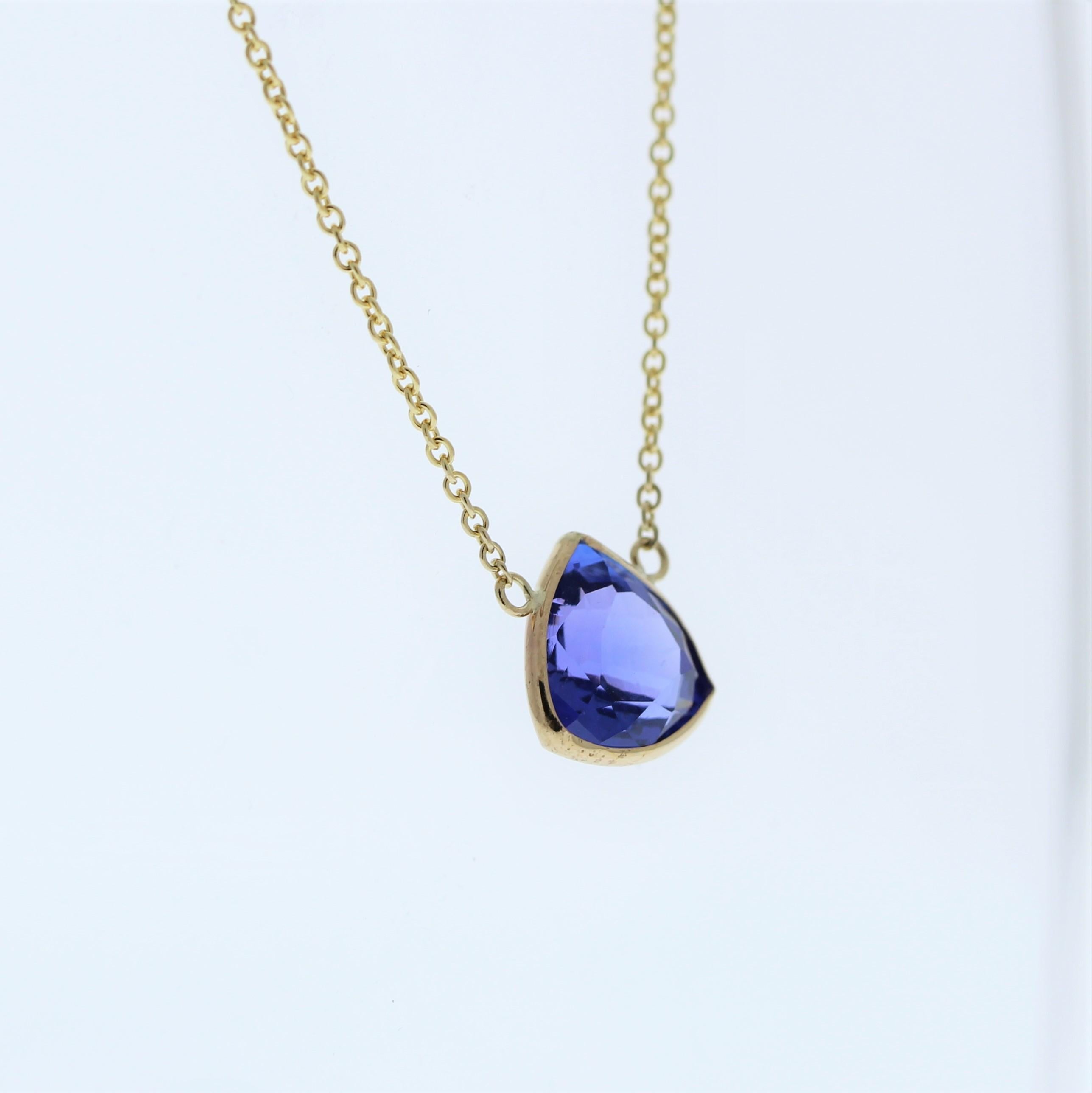 The necklace features a 2.82-carat trilliant-cut tanzanite set in a 14 karat yellow gold pendant or setting. The trilliant cut and the unique blue-violet color of the tanzanite against the yellow gold setting are likely to create an elegant and