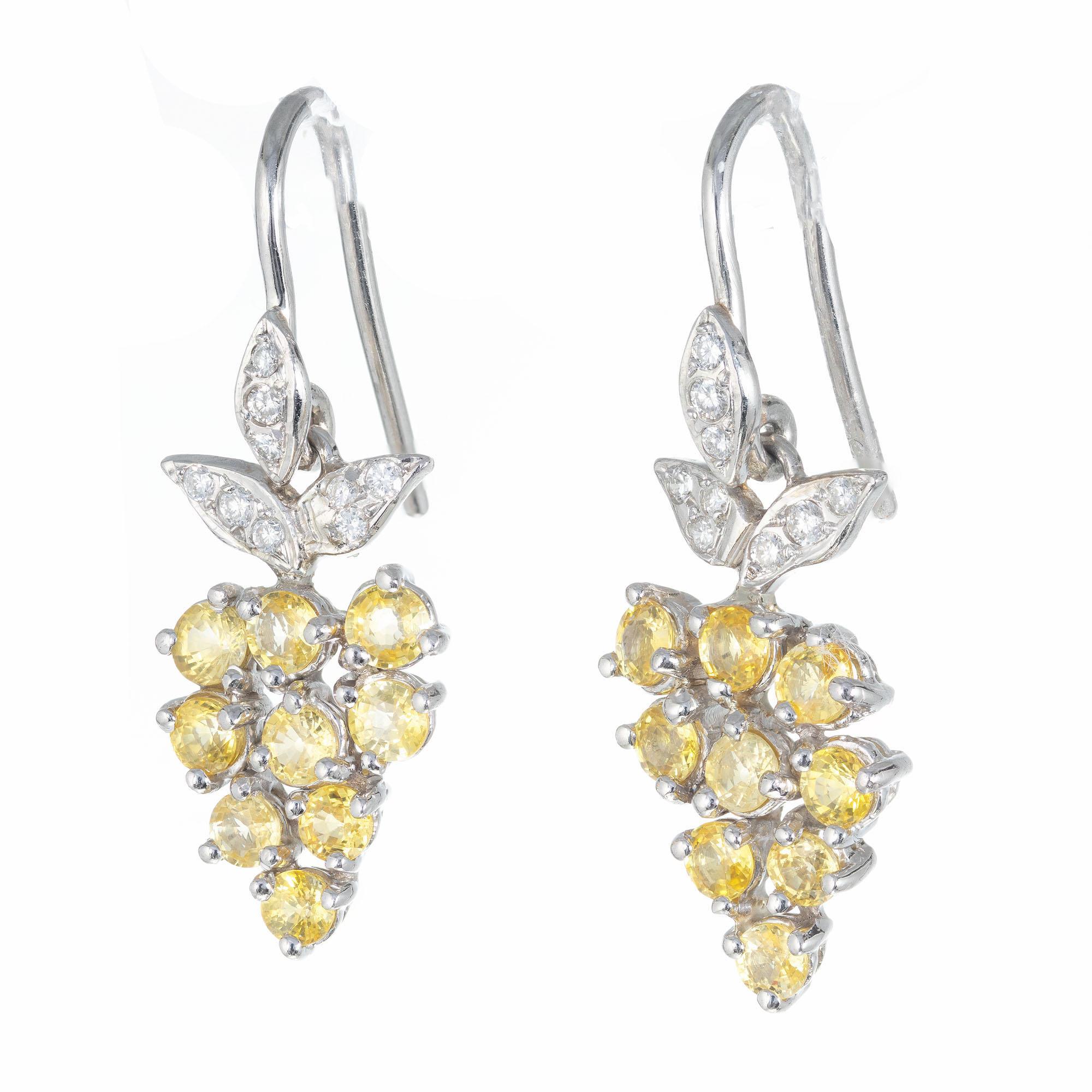 Sapphire and diamond dangle earrings with old European cut yellow Sapphires and Pave set white full cut accent diamonds.

18 round diamonds approx. total weight .12cts
18 round yellow Sapphires approx. total weight 2.70cts
Platinum
Stamped: