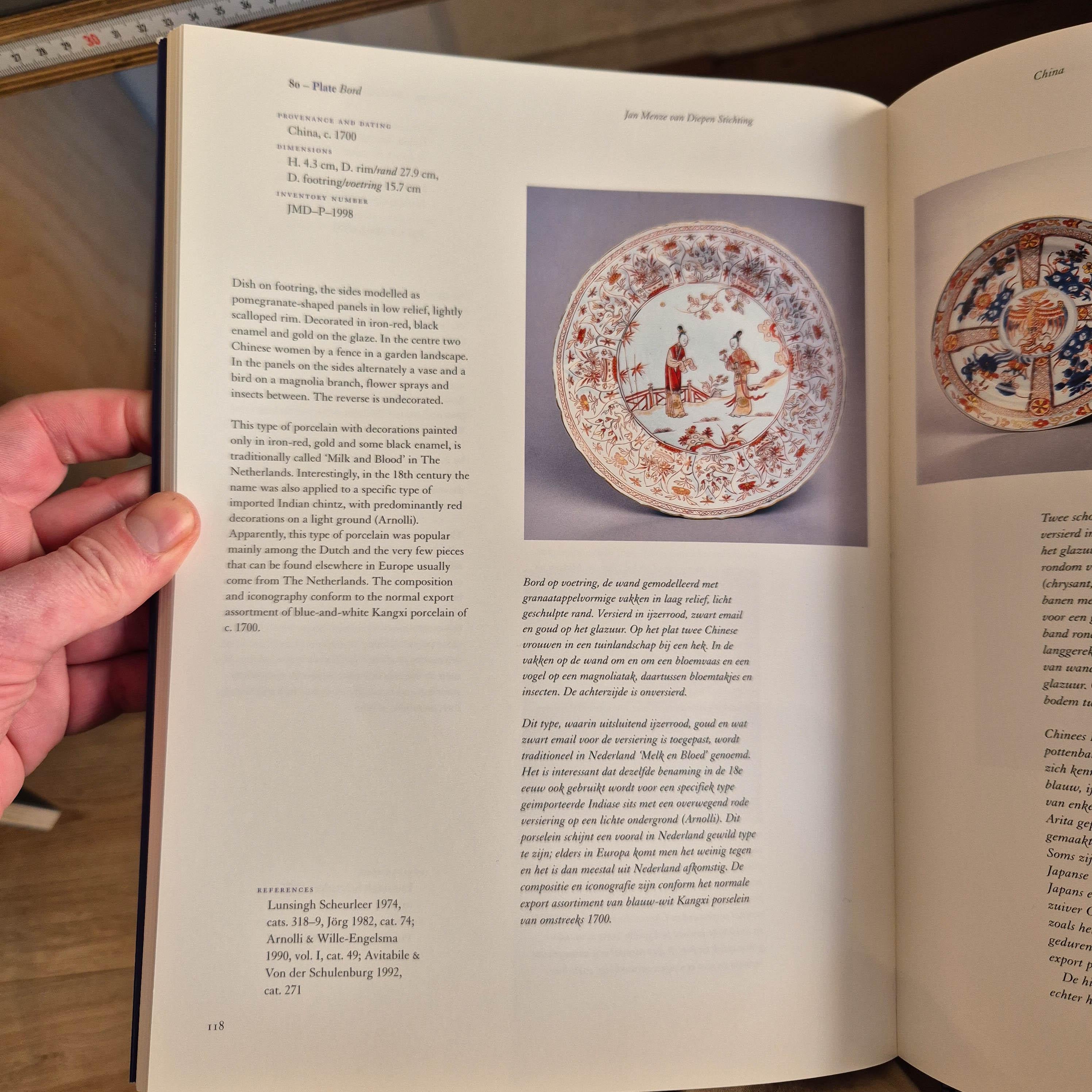 

Sharing with you this lovely dish on footring, the sides modelled as pomegranate-shaped panels in low relief, lightly scalloped rim. Decorated in iron-red and gold on the glaze. In the centre two Chinese women on a boat. In the panels on the sides