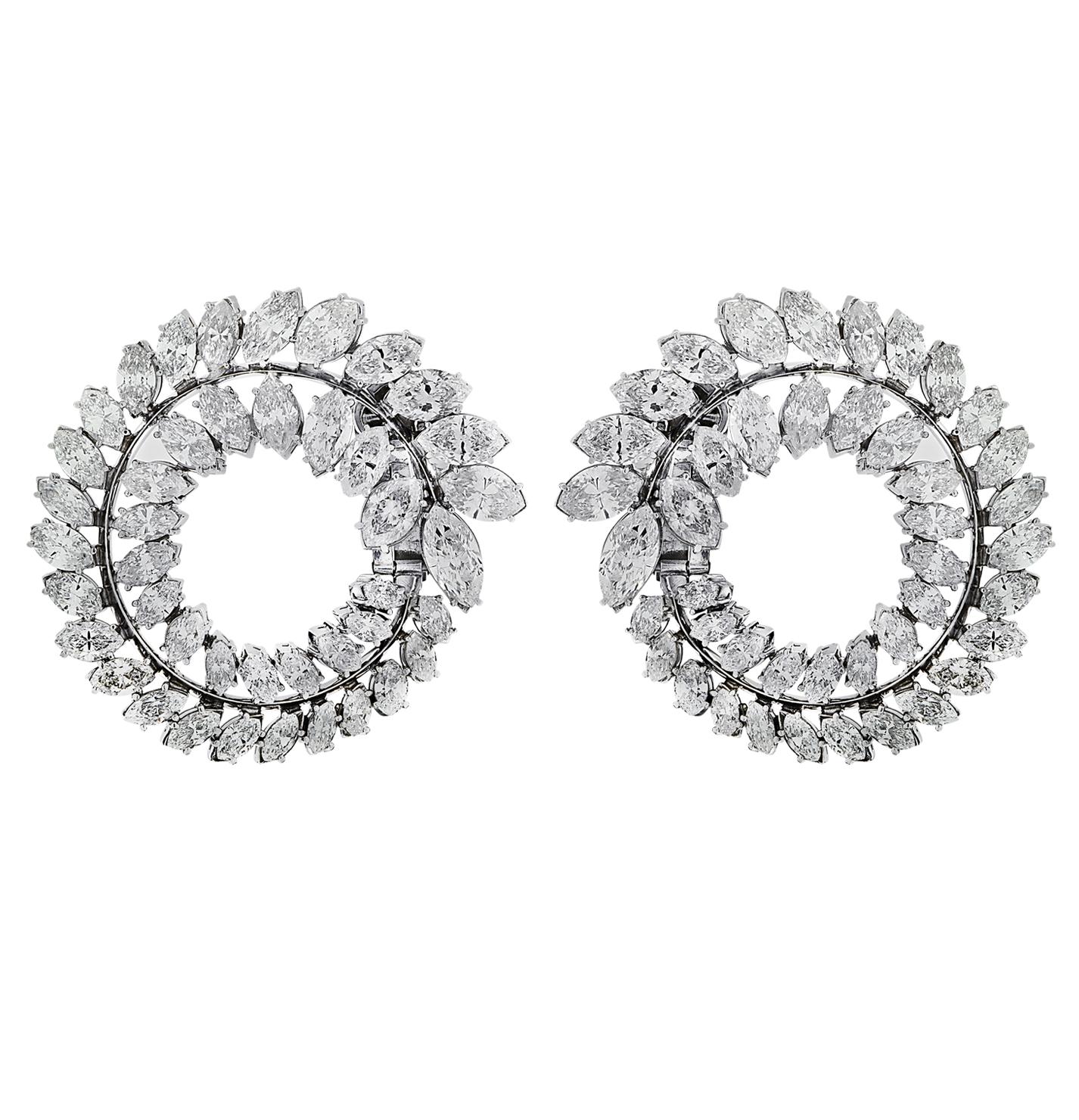 Stunning diamond earrings circa 1950, crafted in platinum, showcasing 86 marquise cut diamonds weighing approximately 28.25 carats total, G-I color, VS-SI clarity. Two rows of diamonds are arranged in open circle designs, which swirl from the front