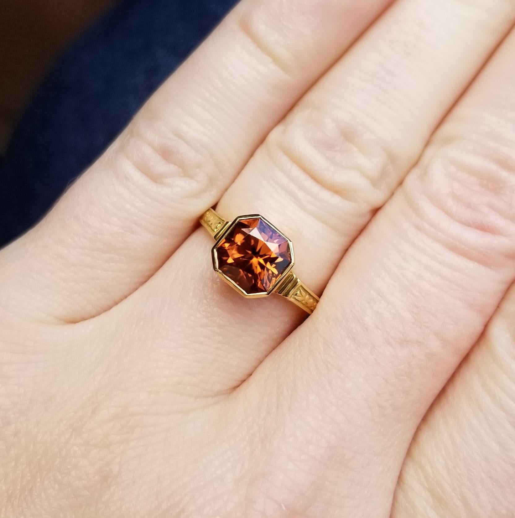 The intensity one expects from a well cut zircon is amplified by the rich, flaming orange-red color of this gorgeous gem from Tanzania. The classic octagon shape is clean and unexpected for the fireball of brilliance that is a good zircon.

This