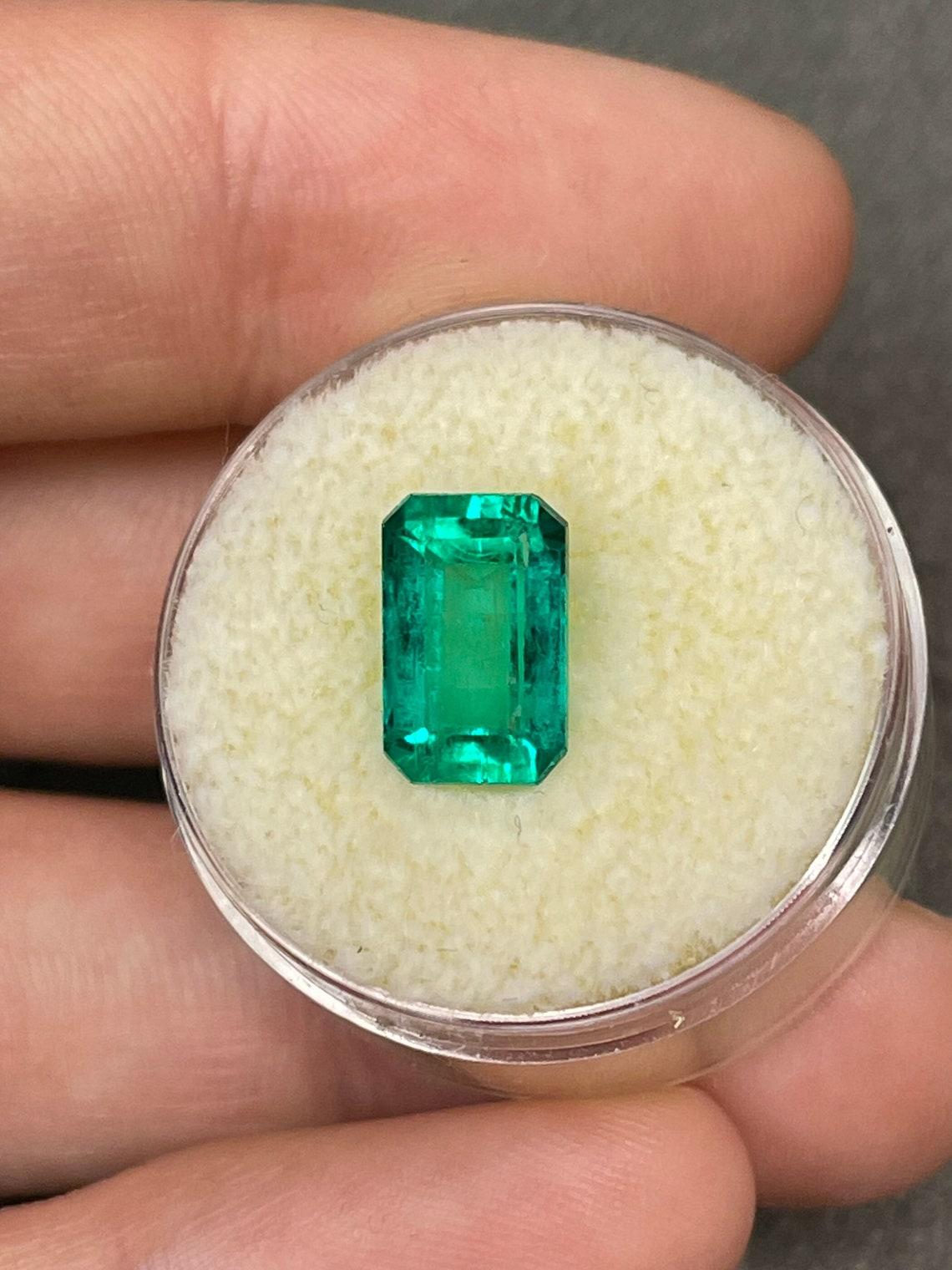 Stone: Emerald
Weight: 2.82-carats
Shape: Emerald Cut
Clarity: Transparent
Luster: Excellent
Color: Vivid Bluish Green
Measurements: 10.64mm x 6.70mm
Geographic Origin: Colombia
Treatment: Natural, Oiling

Comments: Due to their growth conditions in