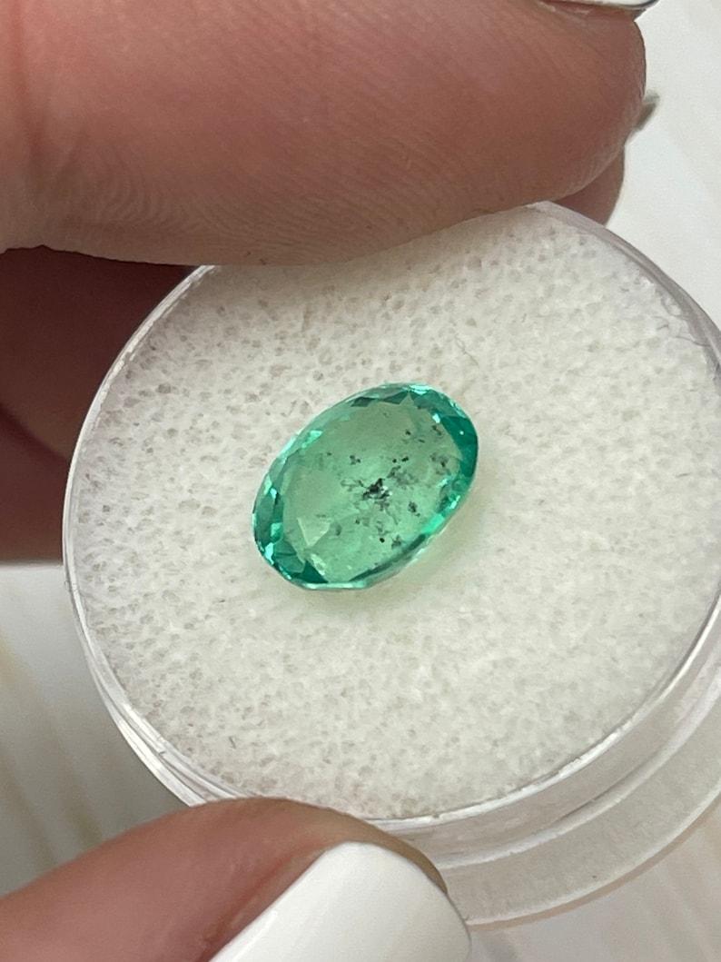 2.83 Carat 10x8mm Vibrant Freckled Green Colombian Emerald Oval Cut - May Births For Sale 1