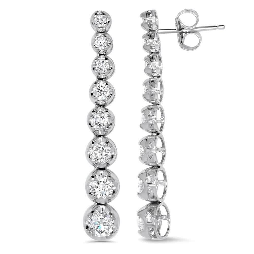 Simple and Stunning, these 2.83 carat diamond earrings feature 16 graduating diamonds, sure to ignite any looK!

Material: 14k White Gold 
Stone Details: 16 Round Graduating White Diamonds at 2.83 Carats. Clarity: SI / Color: H-I

Fine one-of-a-kind