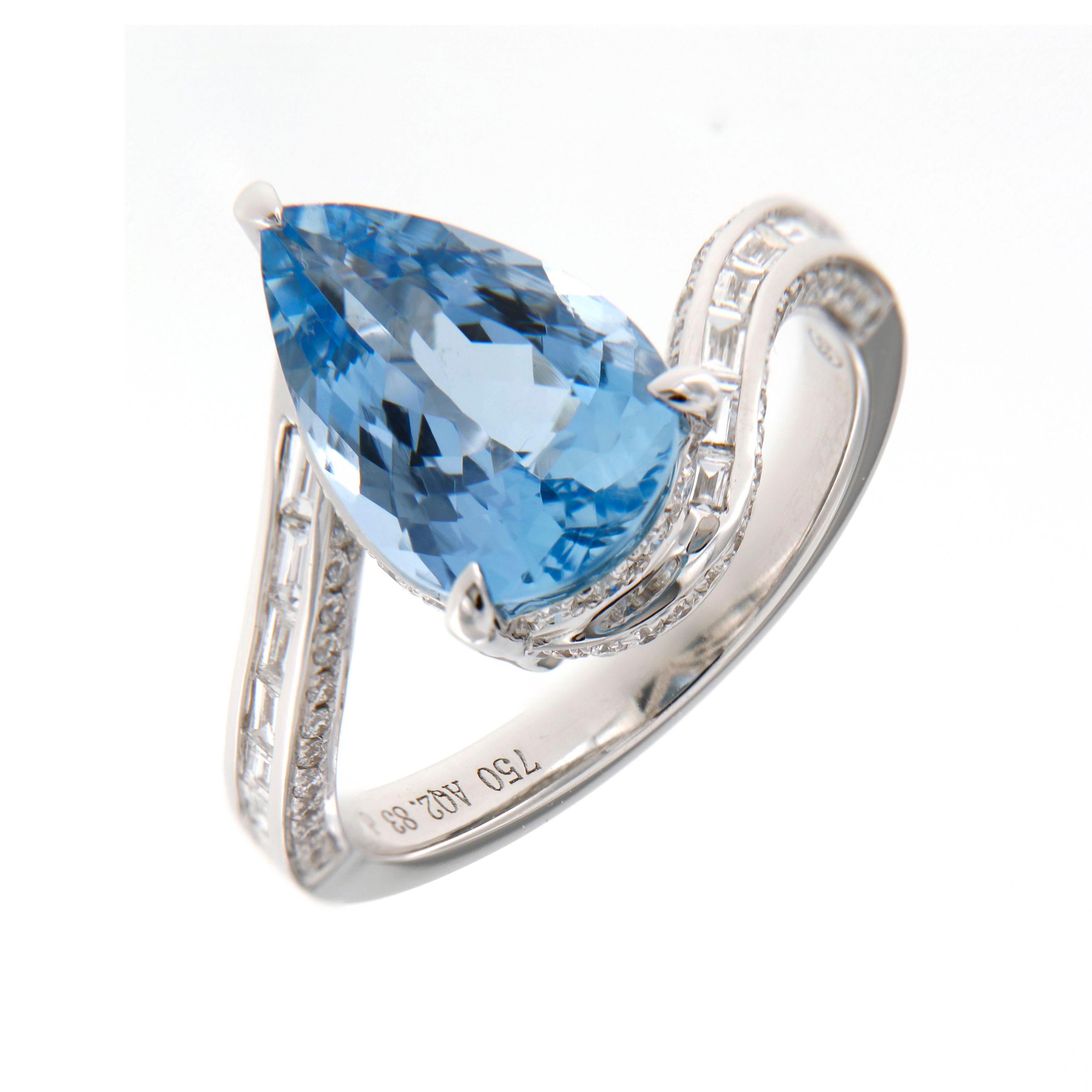 Ocean’s Grace: The Aquamarine and Diamond Ring

This stunning ring is a breathtaking fusion of artistry and elegance, centred around a magnificent 2.83-carat pear-shaped aquamarine. The gemstone’s dazzling blue hue evokes the tranquillity of ocean