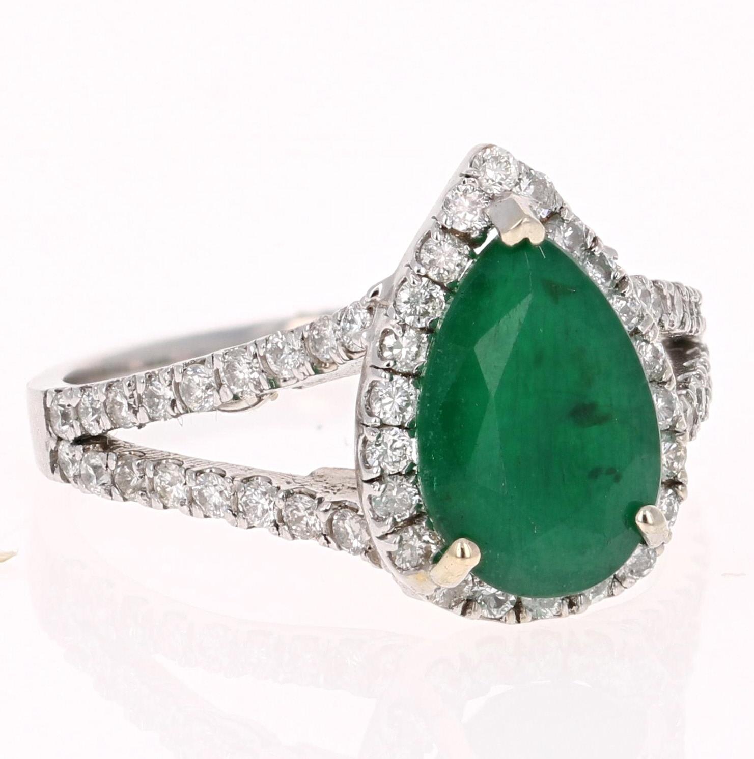 Beautiful Emerald Diamond ring with an eye catching Halo! A unique way to propose and add color to your life! 

The Pear Cut Emerald is 2.19 Carats and is surrounded by 66 Round Cut Diamonds at 0.65 Carats. The Clarity and Color of the Diamonds are