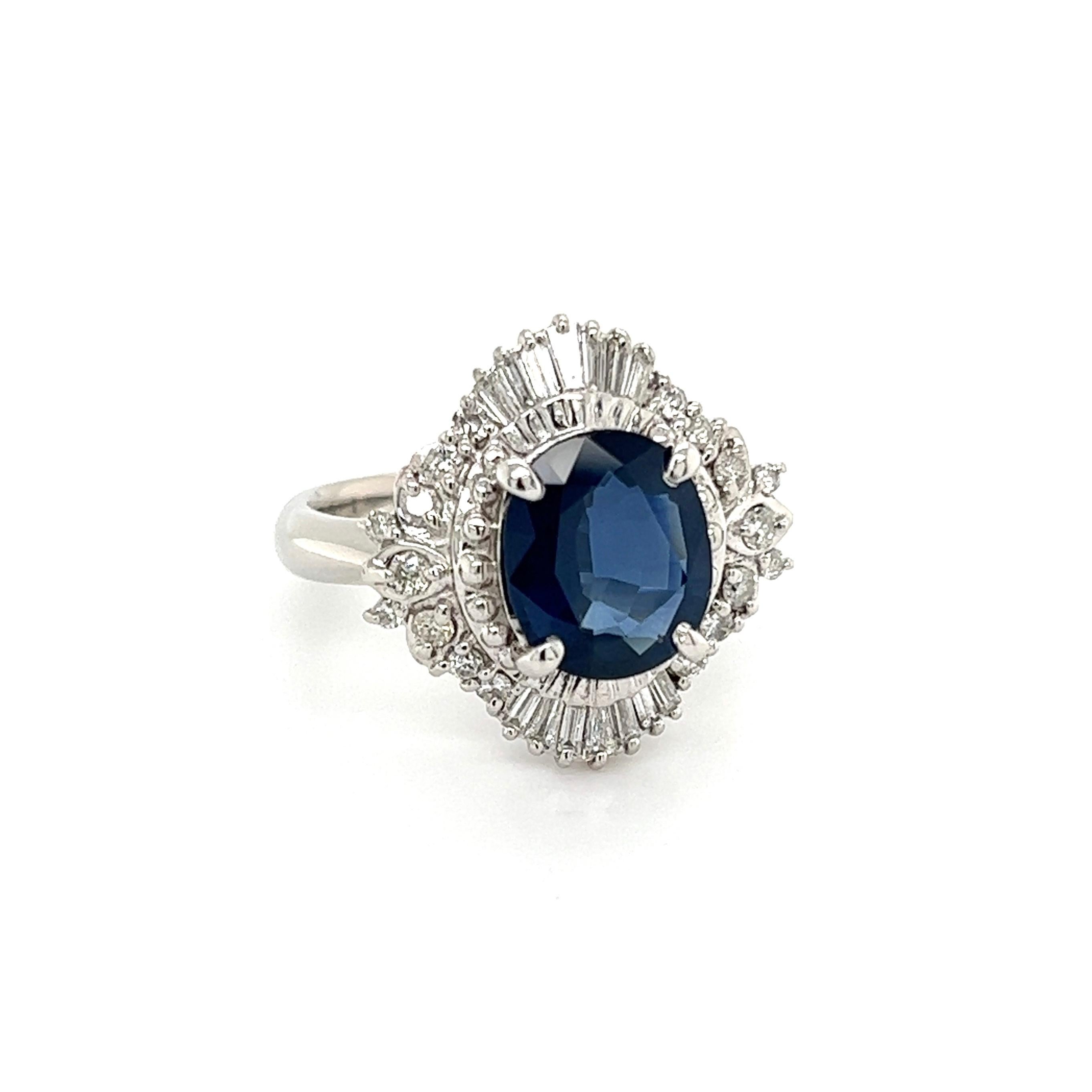Simply Beautiful! Blue Sapphire and Diamond Art Deco Revival Platinum Ring. Centering a securely set Oval Blue Sapphire, weighing approx. 2.84 Carat, surrounded by Diamonds, weighing approx. 0.55tcw. Hand crafted Platinum mounting. Approx.