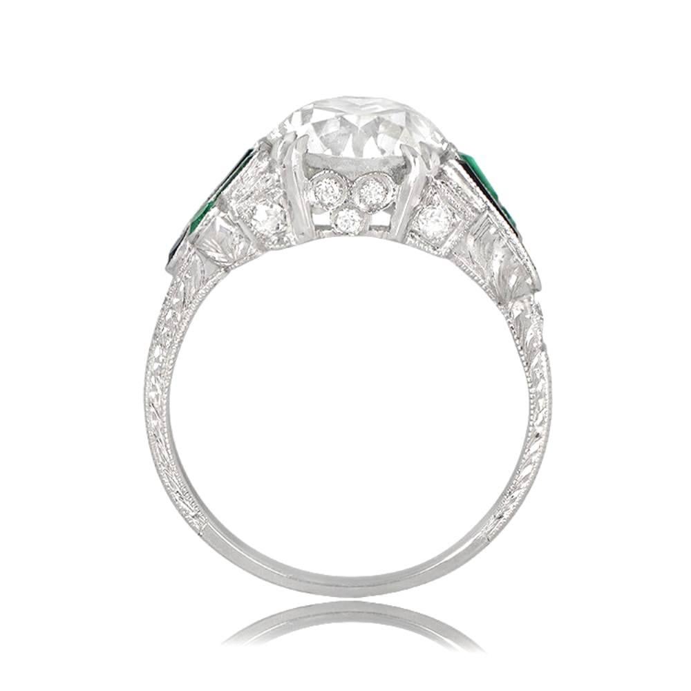 An exquisite Art Deco-inspired Engagement Ring featuring onyx and emerald accents on the shoulders, complementing the center old European cut diamond. The ring is handcrafted in platinum with additional diamonds embellishing the gallery and