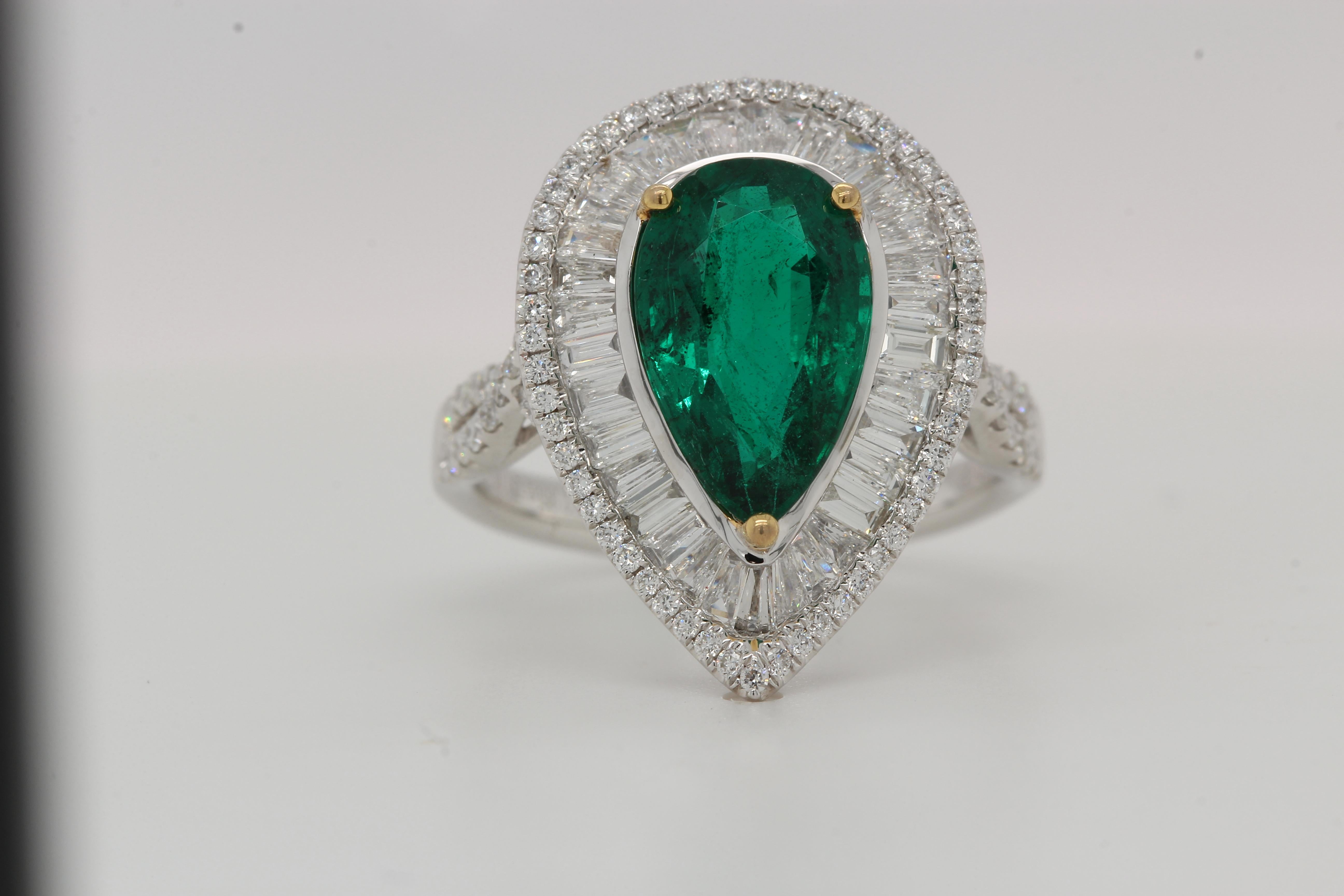 Graceful and elegant, our gorgeous flawless lush green emerald and diamond ring is a timeless symbol of love. A stunning 2.85 carat flawless lush green emerald pear sits set with dazzling white diamonds, making this one-of-a-kind piece a must-have